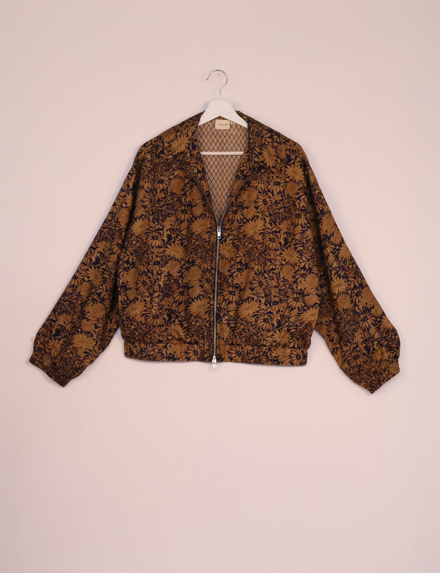 Stylish BOMBER JACKET, an upcycled clothing masterpiece with a cute cropped shape, elasticated details, and detachable metallic zipper. Contrast sari print lining adds a unique touch. Explore sustainable and eco-friendly fashion.