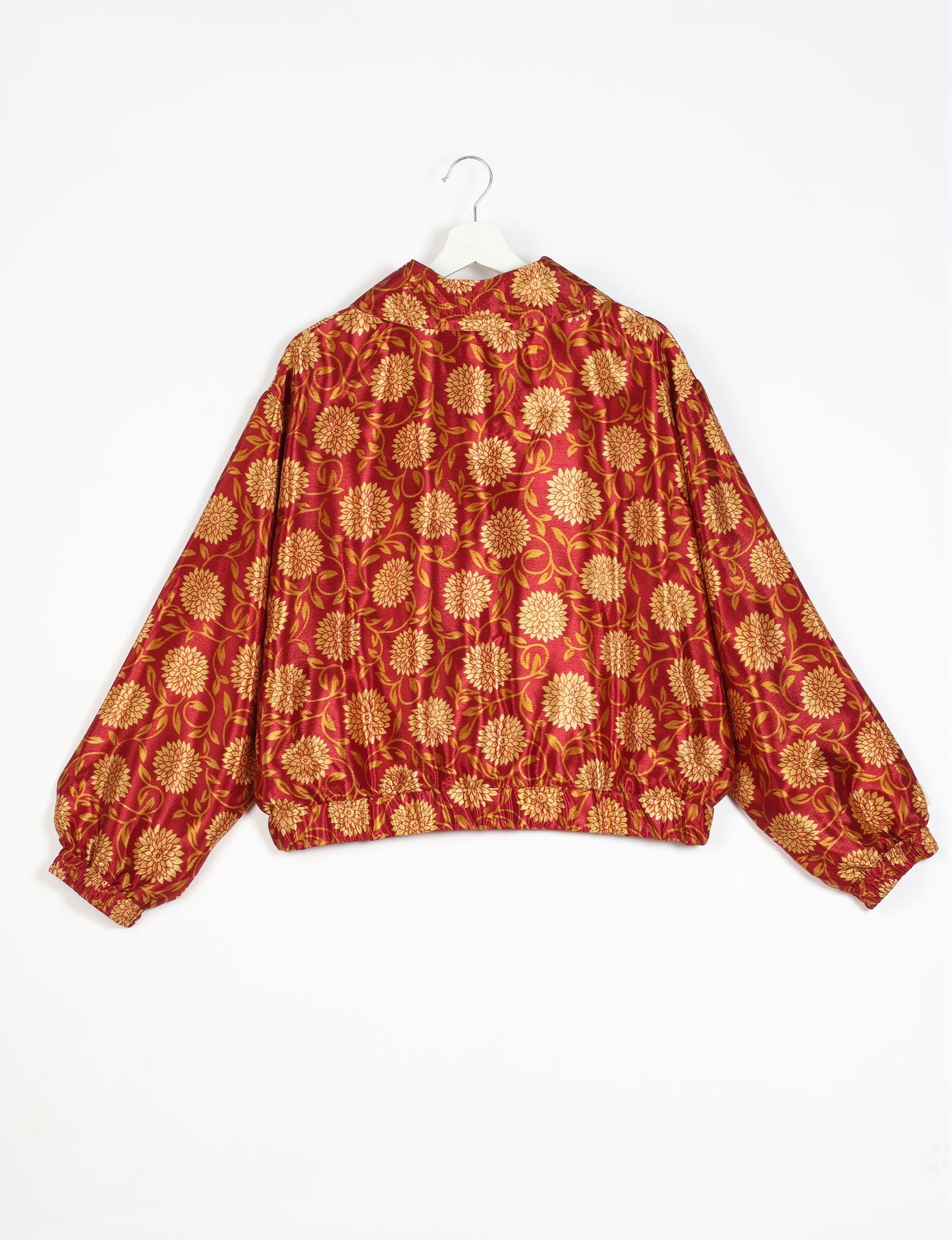 Stylish BOMBER JACKET, an upcycled clothing masterpiece with a cute cropped shape, elasticated details, and detachable metallic zipper. Contrast sari print lining adds a unique touch. Explore sustainable and eco-friendly fashion.