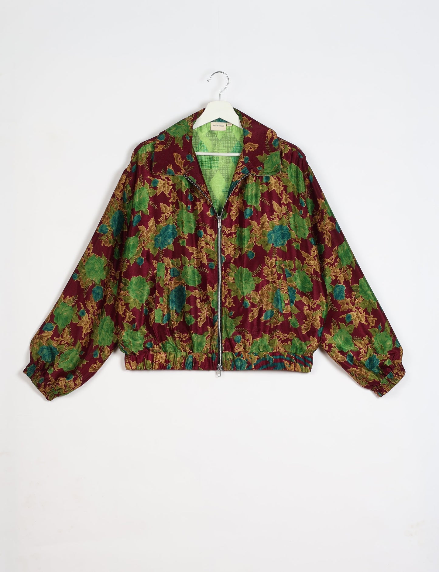 Stylish BOMBER JACKET, an upcycled clothing masterpiece with a cute cropped shape, elasticated details, and detachable metallic zipper. Contrast sari print lining adds a unique touch. Explore sustainable and eco-friendly fashion.