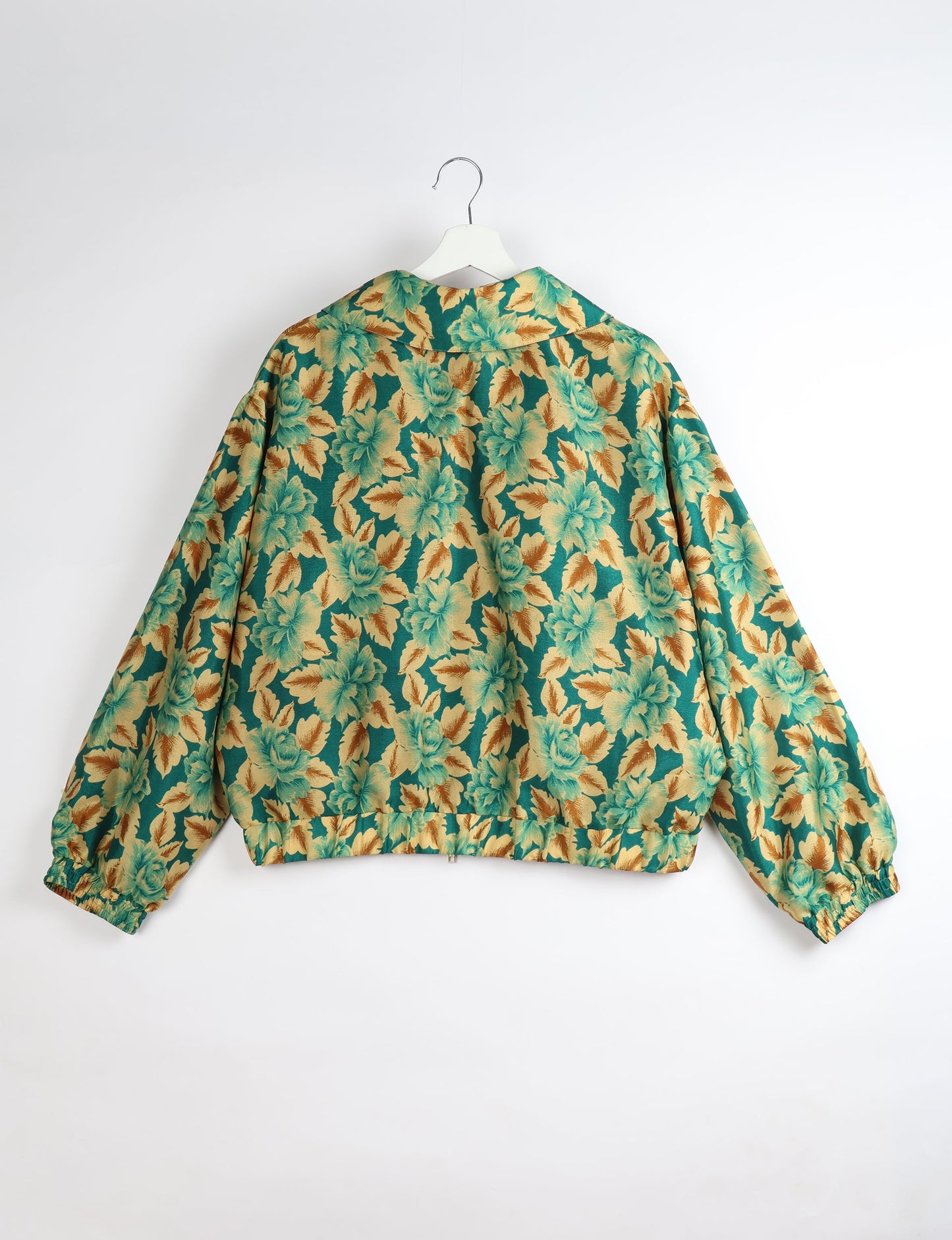 Upcycled Bomber Jacket made from recycled sari materials, featuring a cute cropped shape, elasticated hem and cuffs, and contrast sari print lining. Sustainable apparel promoting eco-friendly fashion and ethical clothing.