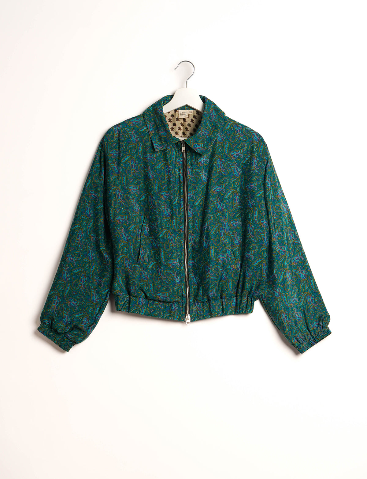 Stylish BOMBER JACKET, an upcycled clothing masterpiece with a cute cropped shape, elasticated details, and detachable metallic zipper. Contrast sari print lining adds a unique touch. Explore sustainable and eco-friendly fashion.