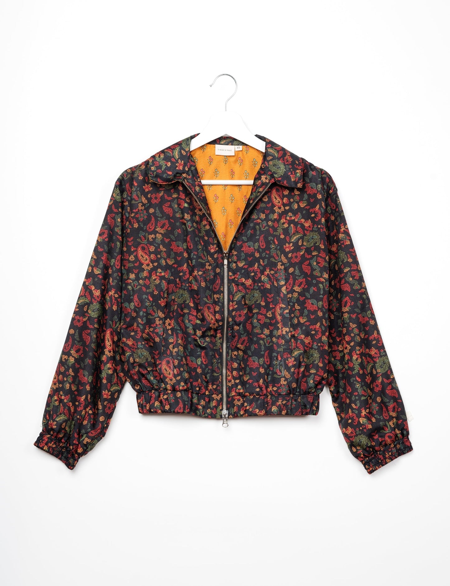 Stylish BOMBER JACKET, an upcycled clothing masterpiece with a cute cropped shape, elasticated details, and detachable metallic zipper. Contrast sari print lining adds a unique touch. Explore sustainable and eco-friendly fashion.