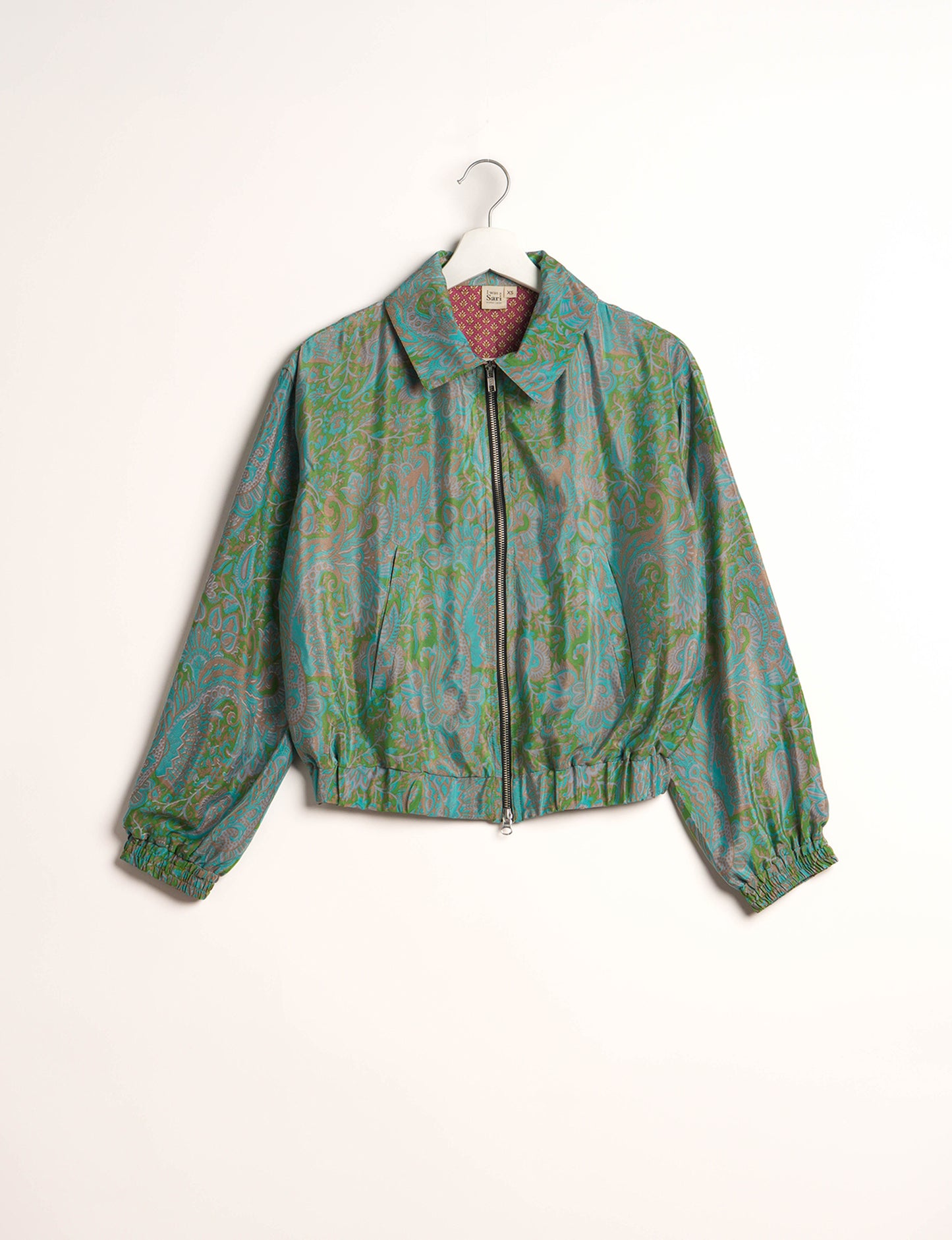 Stylish BOMBER JACKET, an upcycled clothing masterpiece with a cute cropped shape, elasticated details, and detachable metallic zipper. Contrast sari print lining adds a unique touch. Explore sustainable and eco-friendly fashion.