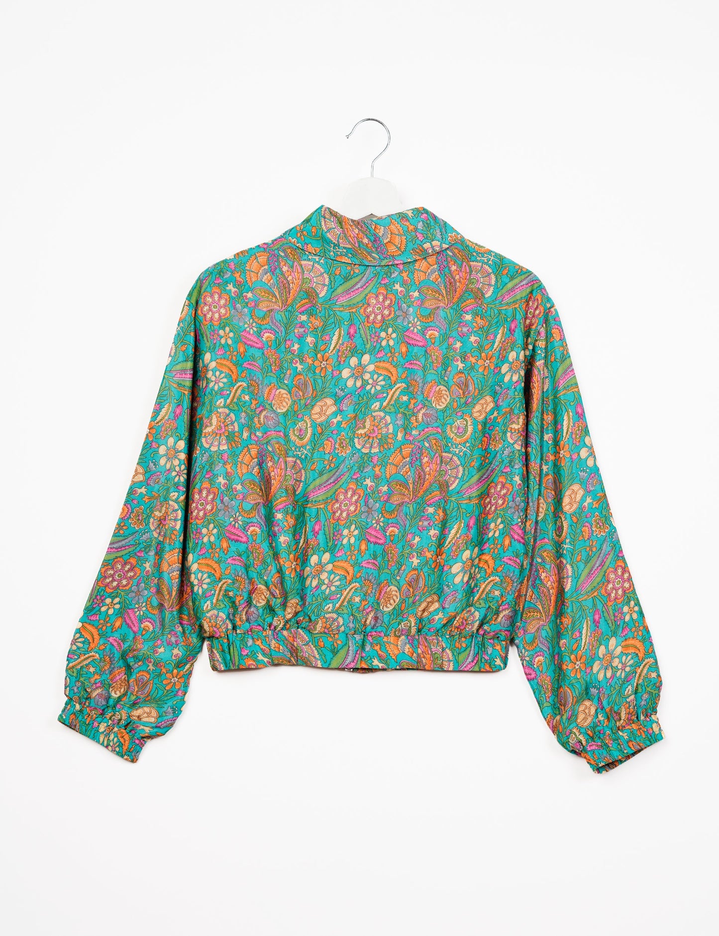 Stylish BOMBER JACKET, an upcycled clothing masterpiece with a cute cropped shape, elasticated details, and detachable metallic zipper. Contrast sari print lining adds a unique touch. Explore sustainable and eco-friendly fashion.