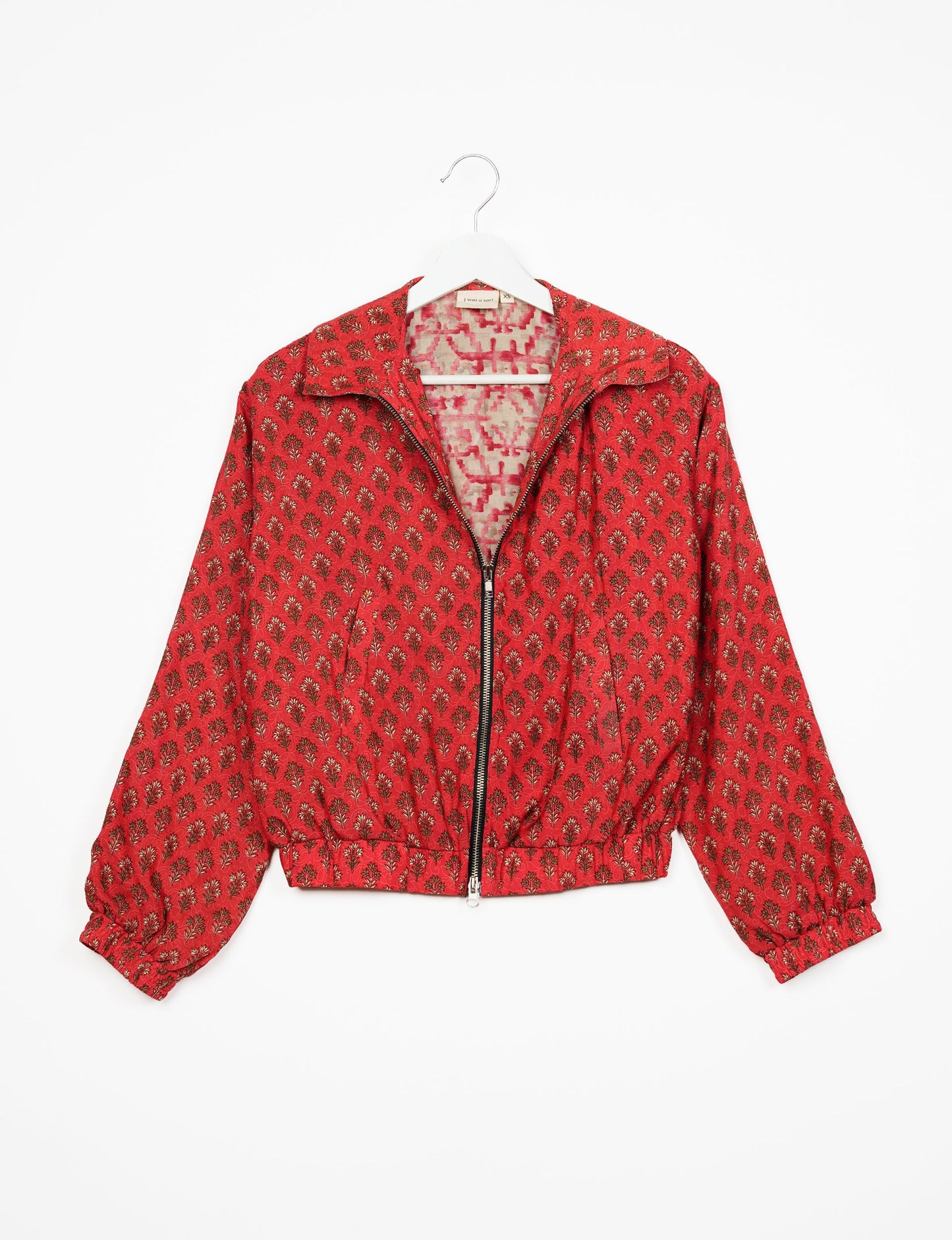 Stylish BOMBER JACKET, an upcycled clothing masterpiece with a cute cropped shape, elasticated details, and detachable metallic zipper. Contrast sari print lining adds a unique touch. Explore sustainable and eco-friendly fashion.