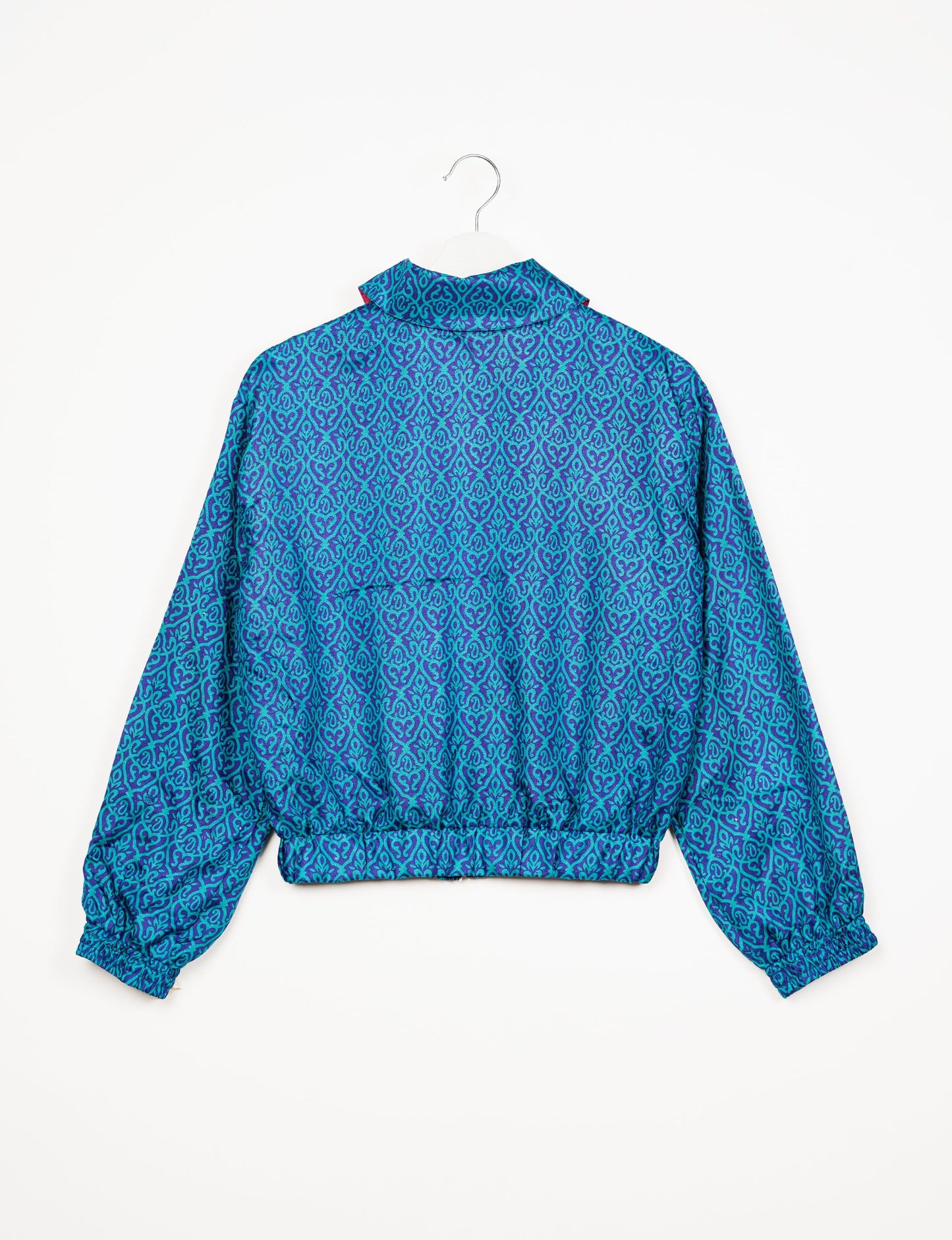 Stylish BOMBER JACKET, an upcycled clothing masterpiece with a cute cropped shape, elasticated details, and detachable metallic zipper. Contrast sari print lining adds a unique touch. Explore sustainable and eco-friendly fashion.