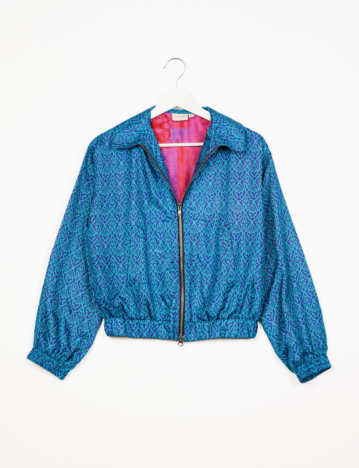 Stylish BOMBER JACKET, an upcycled clothing masterpiece with a cute cropped shape, elasticated details, and detachable metallic zipper. Contrast sari print lining adds a unique touch. Explore sustainable and eco-friendly fashion.