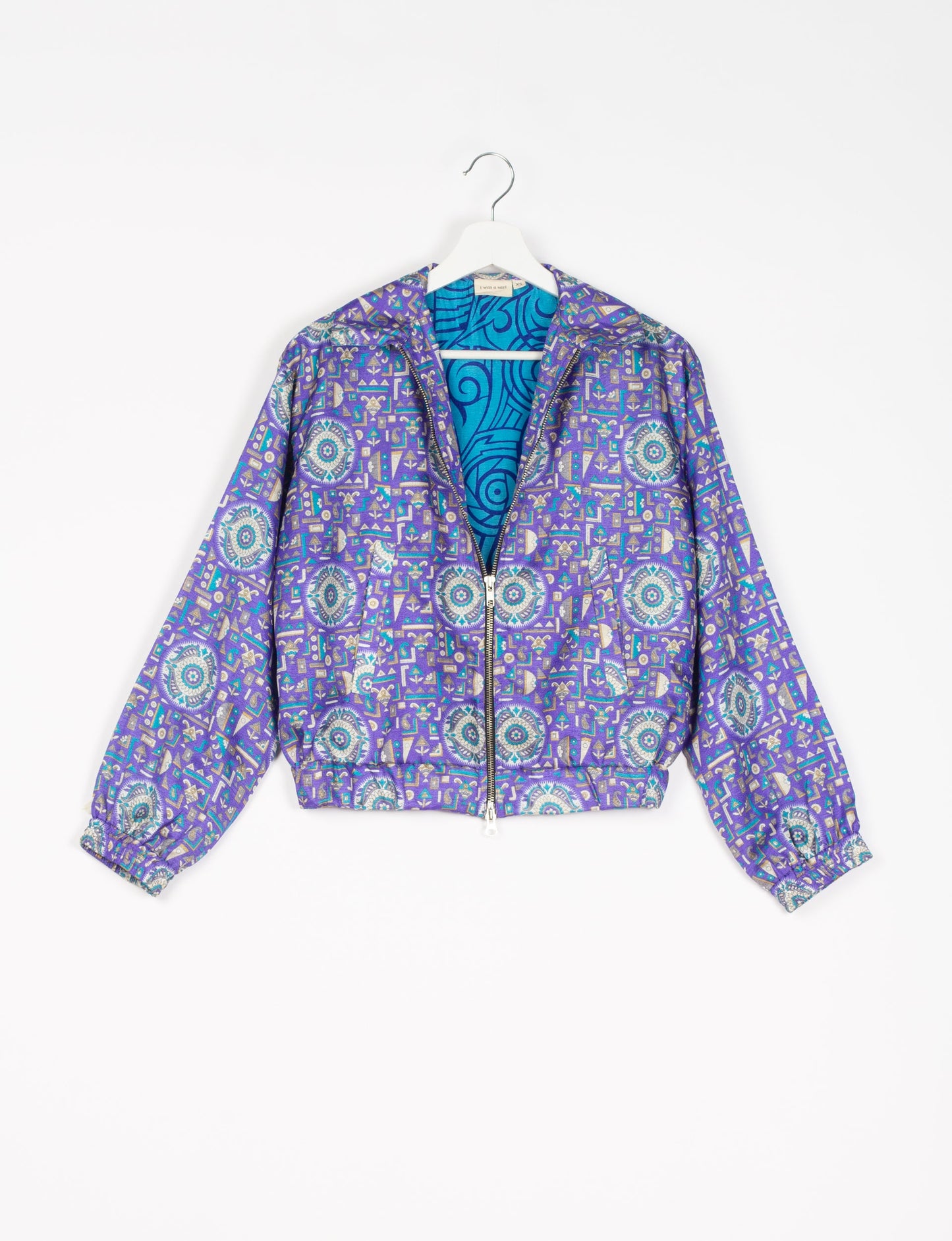 Stylish BOMBER JACKET, an upcycled clothing masterpiece with a cute cropped shape, elasticated details, and detachable metallic zipper. Contrast sari print lining adds a unique touch. Explore sustainable and eco-friendly fashion.