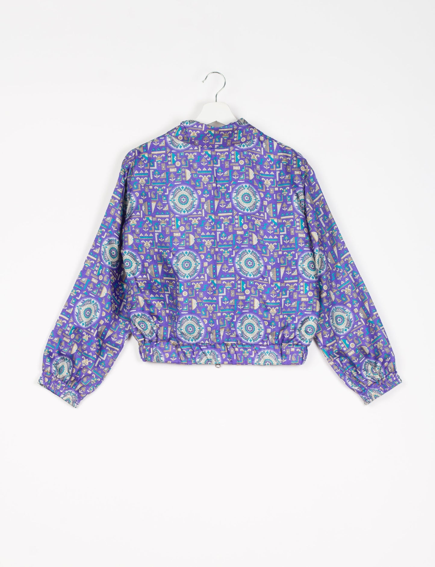 Stylish BOMBER JACKET, an upcycled clothing masterpiece with a cute cropped shape, elasticated details, and detachable metallic zipper. Contrast sari print lining adds a unique touch. Explore sustainable and eco-friendly fashion.