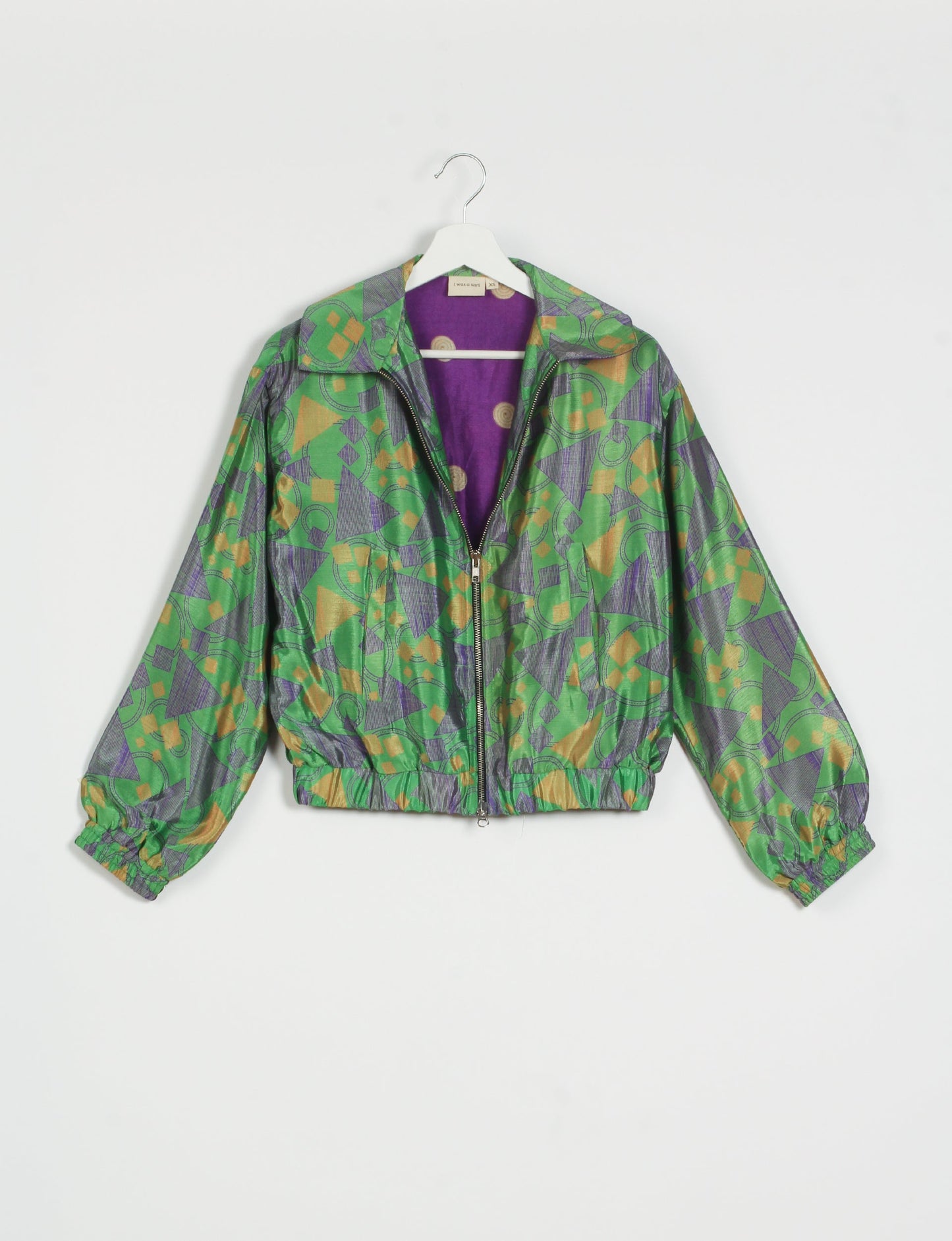 Stylish BOMBER JACKET, an upcycled clothing masterpiece with a cute cropped shape, elasticated details, and detachable metallic zipper. Contrast sari print lining adds a unique touch. Explore sustainable and eco-friendly fashion.