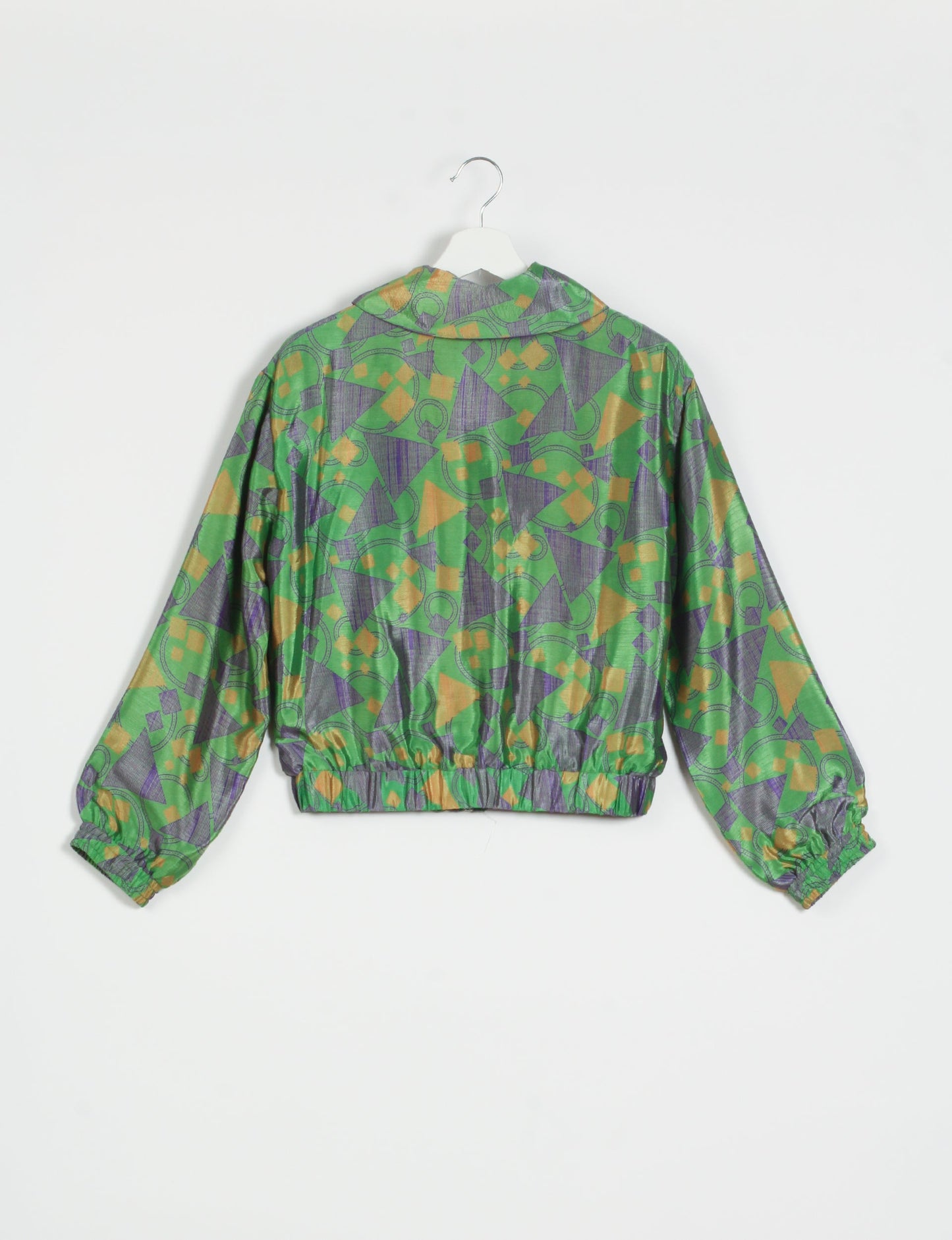 Stylish BOMBER JACKET, an upcycled clothing masterpiece with a cute cropped shape, elasticated details, and detachable metallic zipper. Contrast sari print lining adds a unique touch. Explore sustainable and eco-friendly fashion.