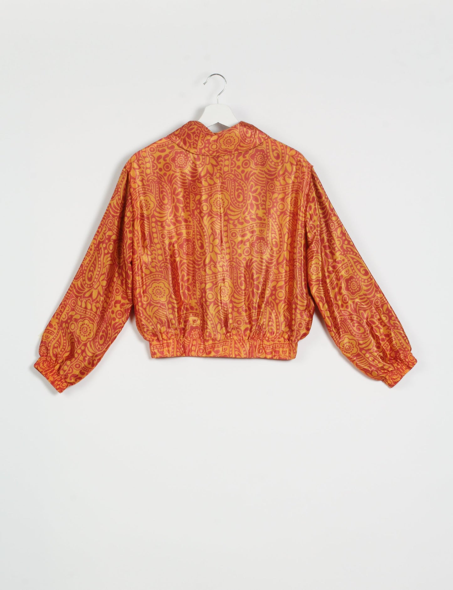 Stylish BOMBER JACKET, an upcycled clothing masterpiece with a cute cropped shape, elasticated details, and detachable metallic zipper. Contrast sari print lining adds a unique touch. Explore sustainable and eco-friendly fashion.