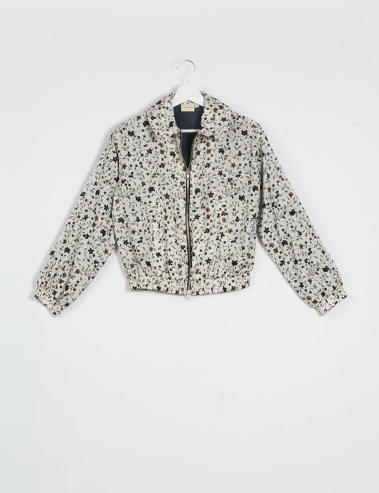 Stylish BOMBER JACKET, an upcycled clothing masterpiece with a cute cropped shape, elasticated details, and detachable metallic zipper. Contrast sari print lining adds a unique touch. Explore sustainable and eco-friendly fashion.