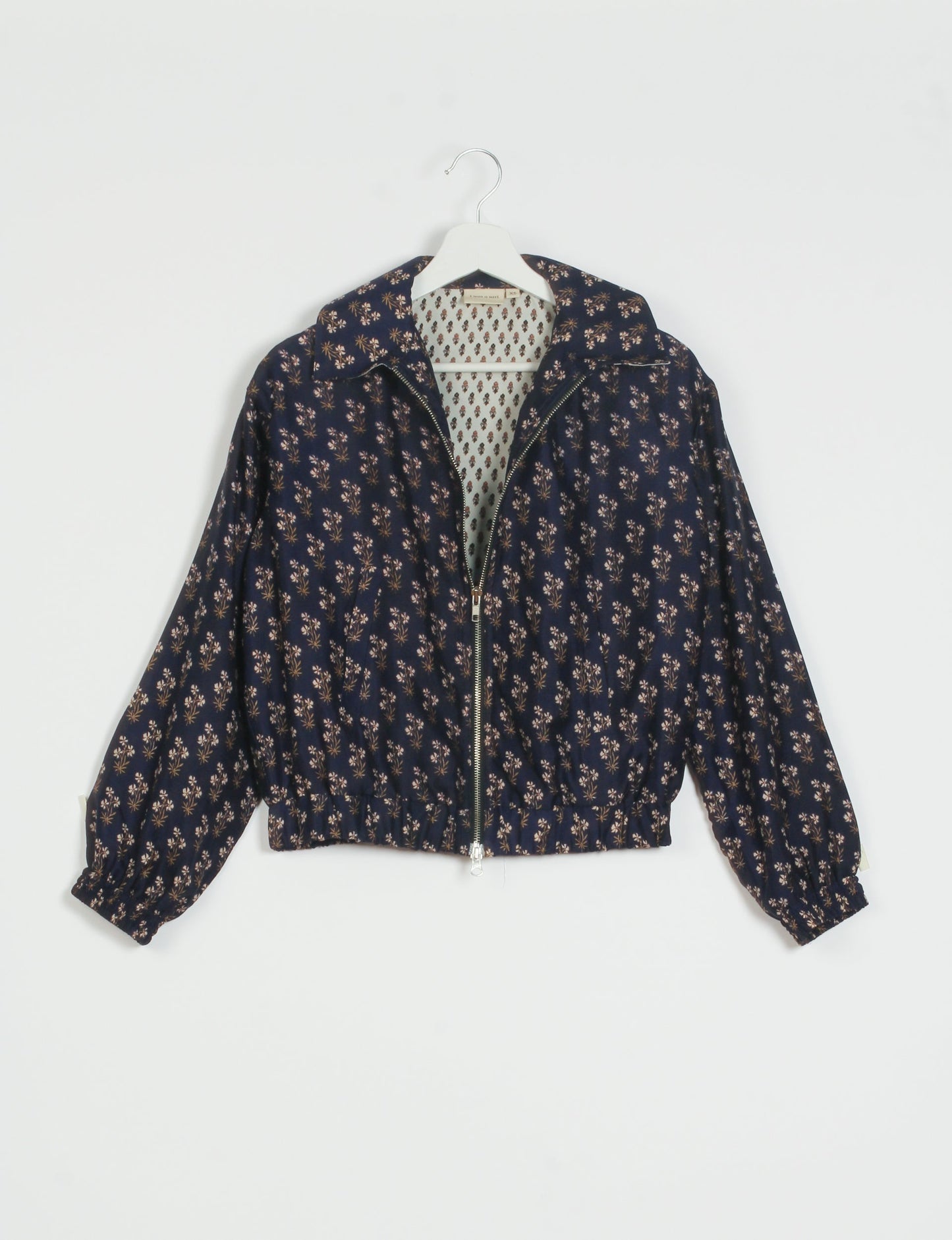 Stylish BOMBER JACKET, an upcycled clothing masterpiece with a cute cropped shape, elasticated details, and detachable metallic zipper. Contrast sari print lining adds a unique touch. Explore sustainable and eco-friendly fashion.