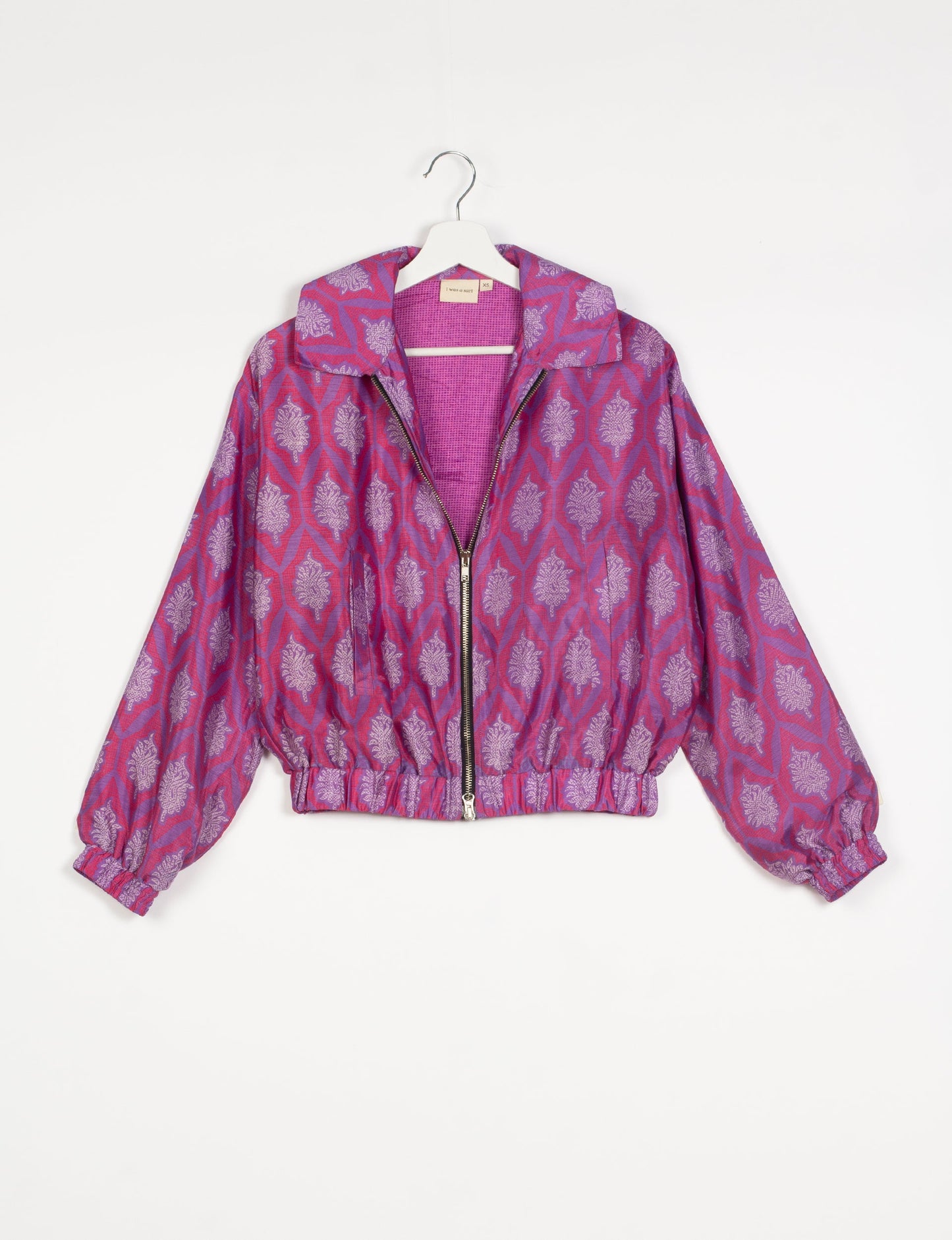 Stylish BOMBER JACKET, an upcycled clothing masterpiece with a cute cropped shape, elasticated details, and detachable metallic zipper. Contrast sari print lining adds a unique touch. Explore sustainable and eco-friendly fashion.