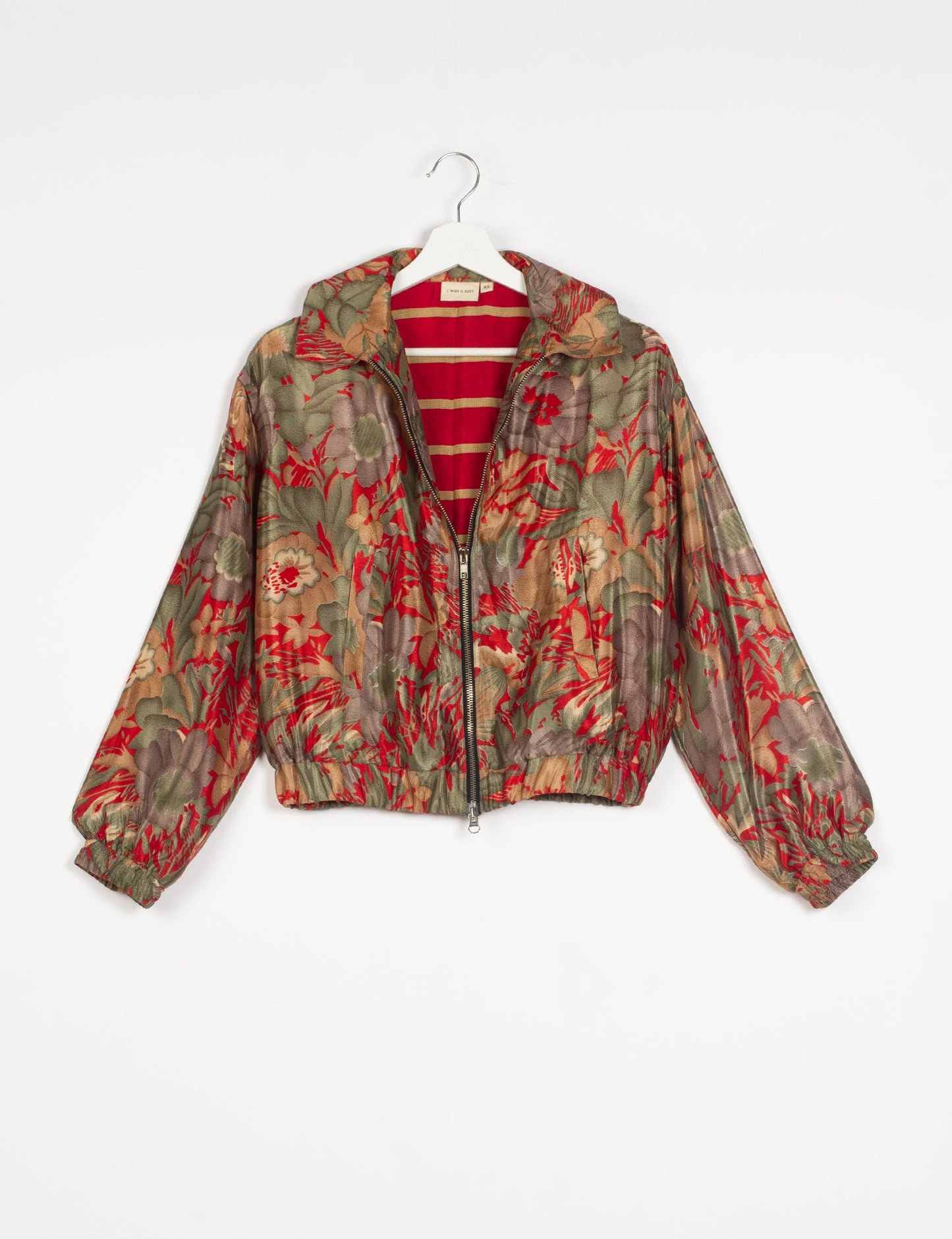 Stylish BOMBER JACKET, an upcycled clothing masterpiece with a cute cropped shape, elasticated details, and detachable metallic zipper. Contrast sari print lining adds a unique touch. Explore sustainable and eco-friendly fashion.