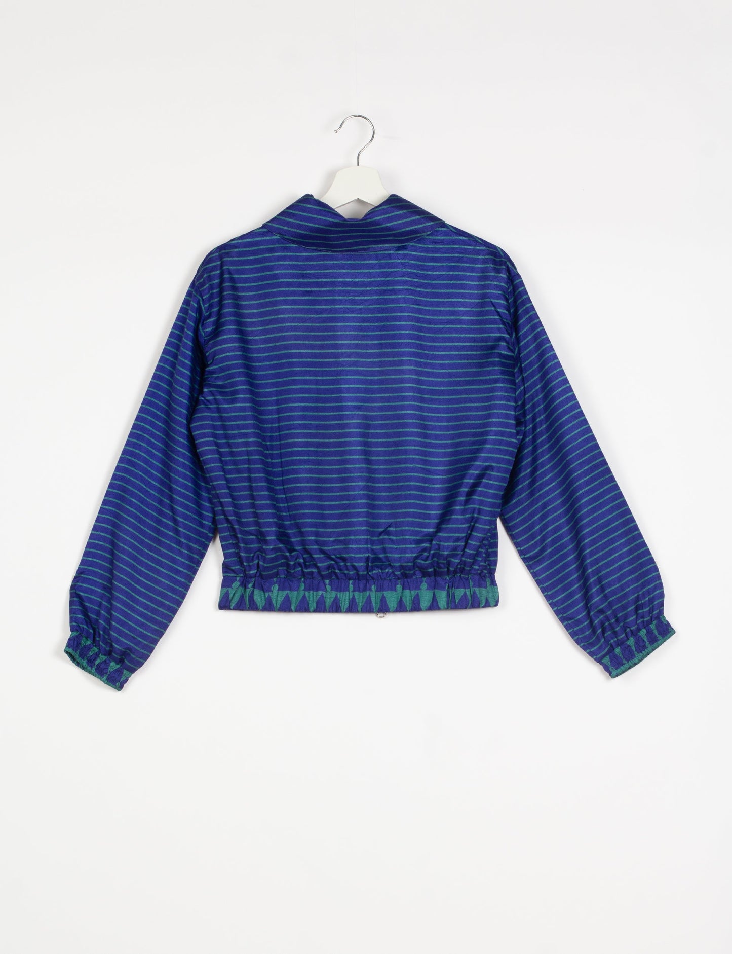 Stylish BOMBER JACKET, an upcycled clothing masterpiece with a cute cropped shape, elasticated details, and detachable metallic zipper. Contrast sari print lining adds a unique touch. Explore sustainable and eco-friendly fashion.