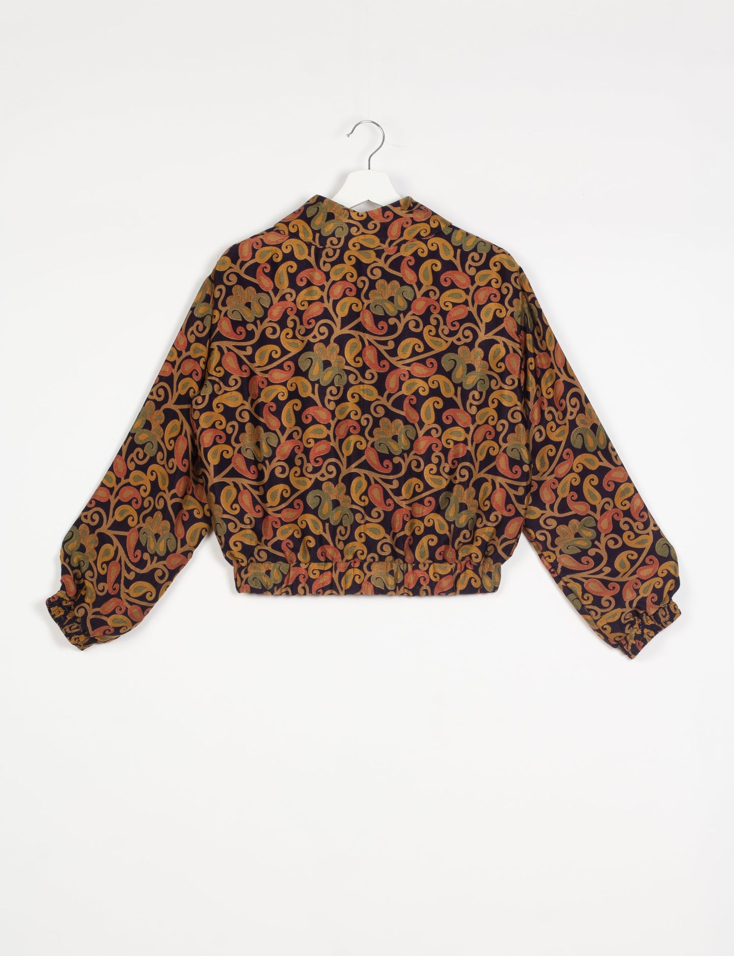 Stylish BOMBER JACKET, an upcycled clothing masterpiece with a cute cropped shape, elasticated details, and detachable metallic zipper. Contrast sari print lining adds a unique touch. Explore sustainable and eco-friendly fashion.