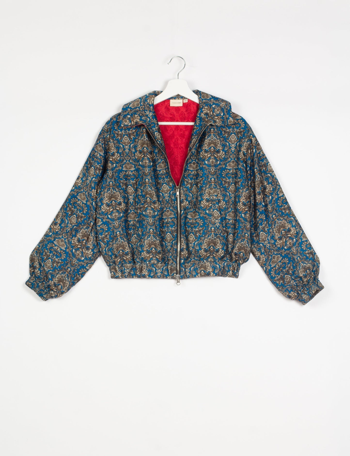 Stylish BOMBER JACKET, an upcycled clothing masterpiece with a cute cropped shape, elasticated details, and detachable metallic zipper. Contrast sari print lining adds a unique touch. Explore sustainable and eco-friendly fashion.