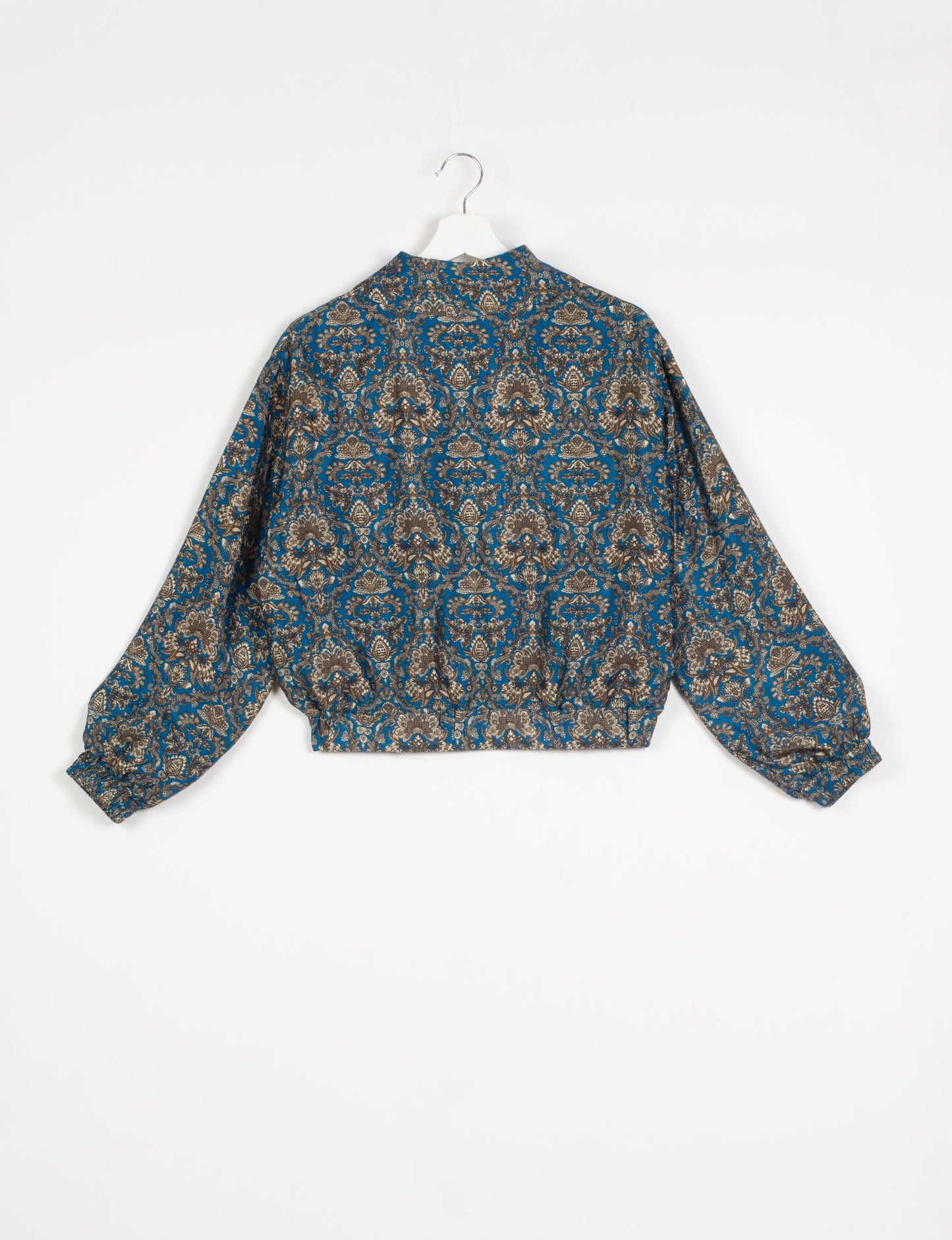 Stylish BOMBER JACKET, an upcycled clothing masterpiece with a cute cropped shape, elasticated details, and detachable metallic zipper. Contrast sari print lining adds a unique touch. Explore sustainable and eco-friendly fashion.