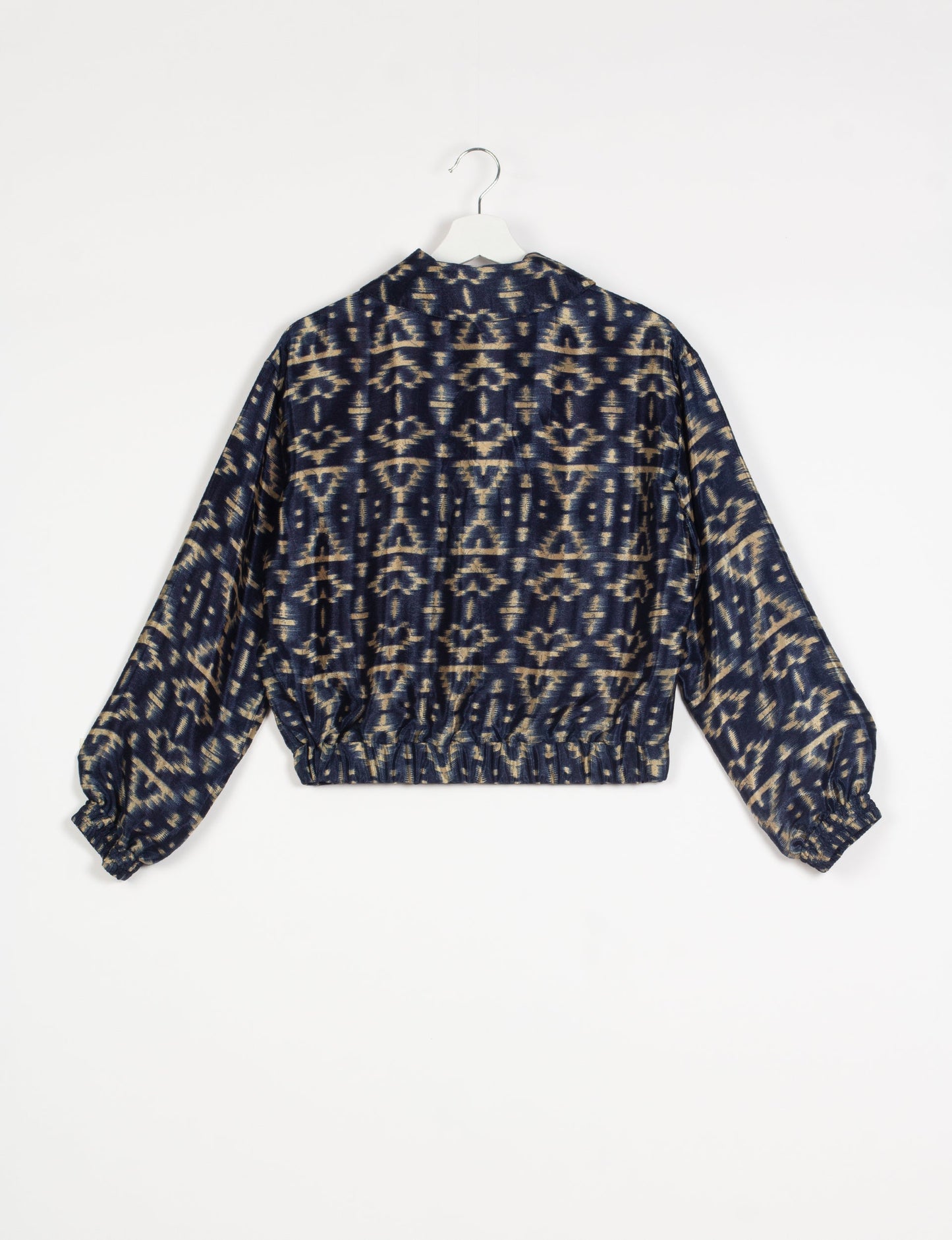 Stylish BOMBER JACKET, an upcycled clothing masterpiece with a cute cropped shape, elasticated details, and detachable metallic zipper. Contrast sari print lining adds a unique touch. Explore sustainable and eco-friendly fashion.