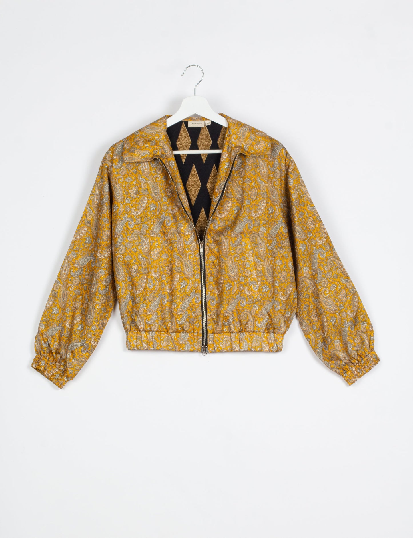 Stylish BOMBER JACKET, an upcycled clothing masterpiece with a cute cropped shape, elasticated details, and detachable metallic zipper. Contrast sari print lining adds a unique touch. Explore sustainable and eco-friendly fashion.