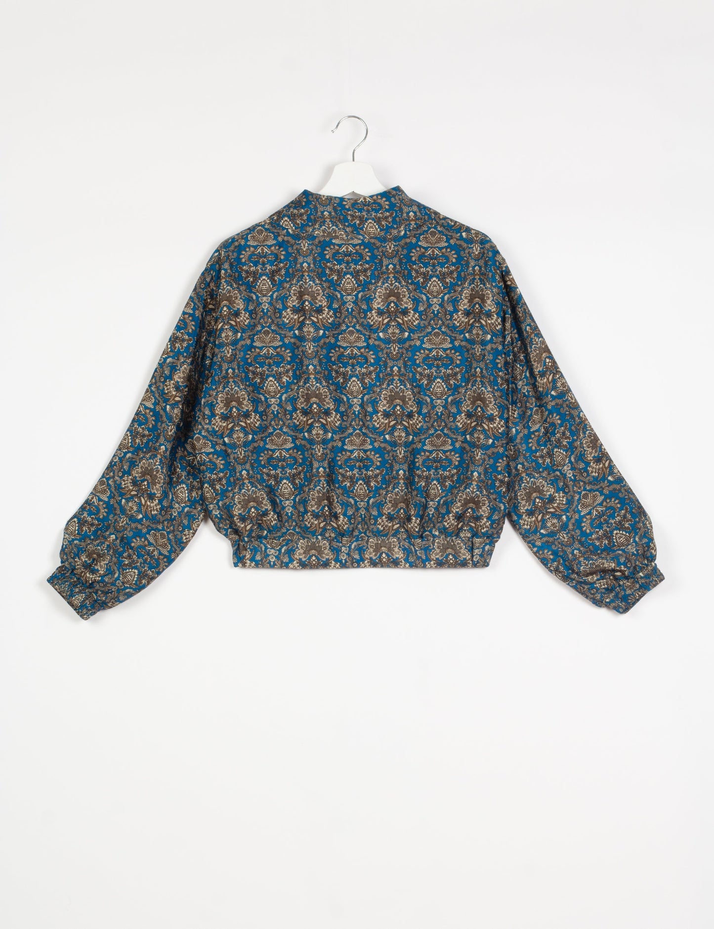 Stylish BOMBER JACKET, an upcycled clothing masterpiece with a cute cropped shape, elasticated details, and detachable metallic zipper. Contrast sari print lining adds a unique touch. Explore sustainable and eco-friendly fashion.