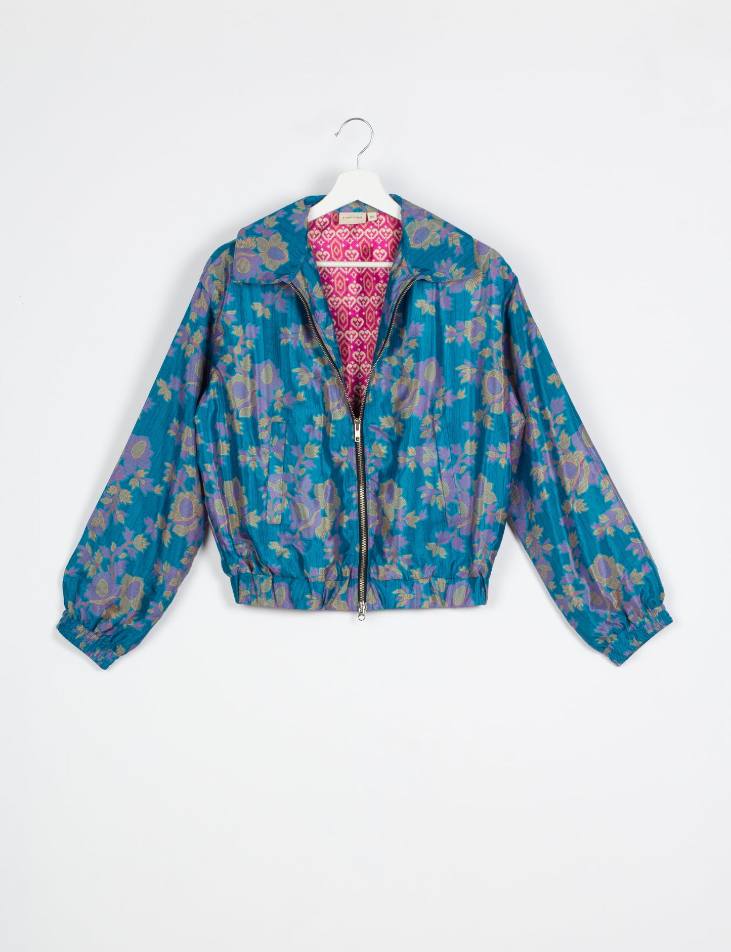 Stylish BOMBER JACKET, an upcycled clothing masterpiece with a cute cropped shape, elasticated details, and detachable metallic zipper. Contrast sari print lining adds a unique touch. Explore sustainable and eco-friendly fashion.