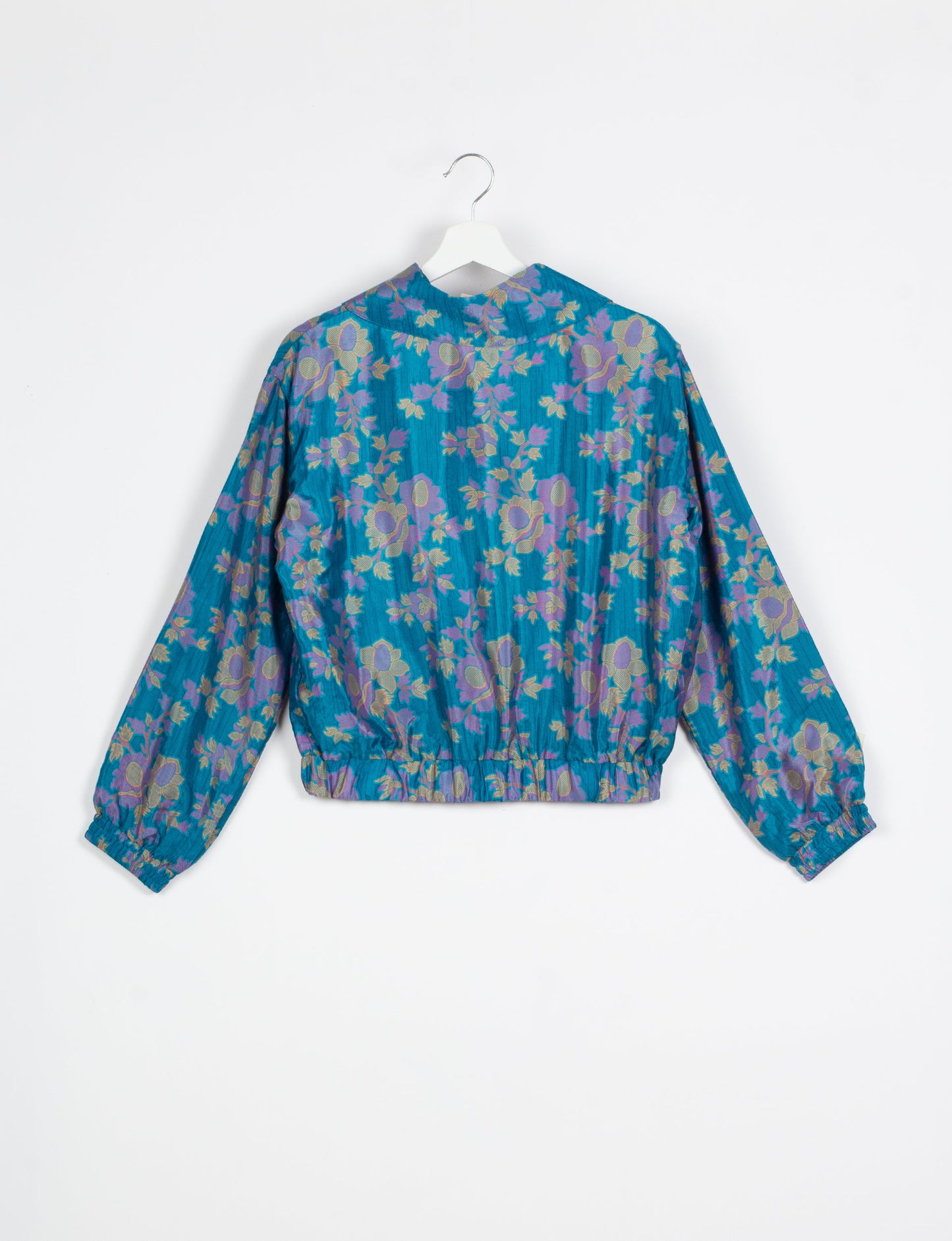 Stylish BOMBER JACKET, an upcycled clothing masterpiece with a cute cropped shape, elasticated details, and detachable metallic zipper. Contrast sari print lining adds a unique touch. Explore sustainable and eco-friendly fashion.