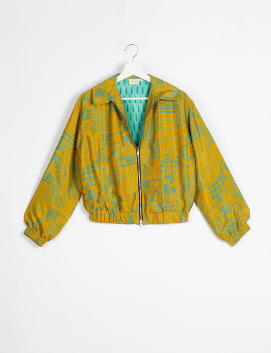 Stylish BOMBER JACKET, an upcycled clothing masterpiece with a cute cropped shape, elasticated details, and detachable metallic zipper. Contrast sari print lining adds a unique touch. Explore sustainable and eco-friendly fashion.