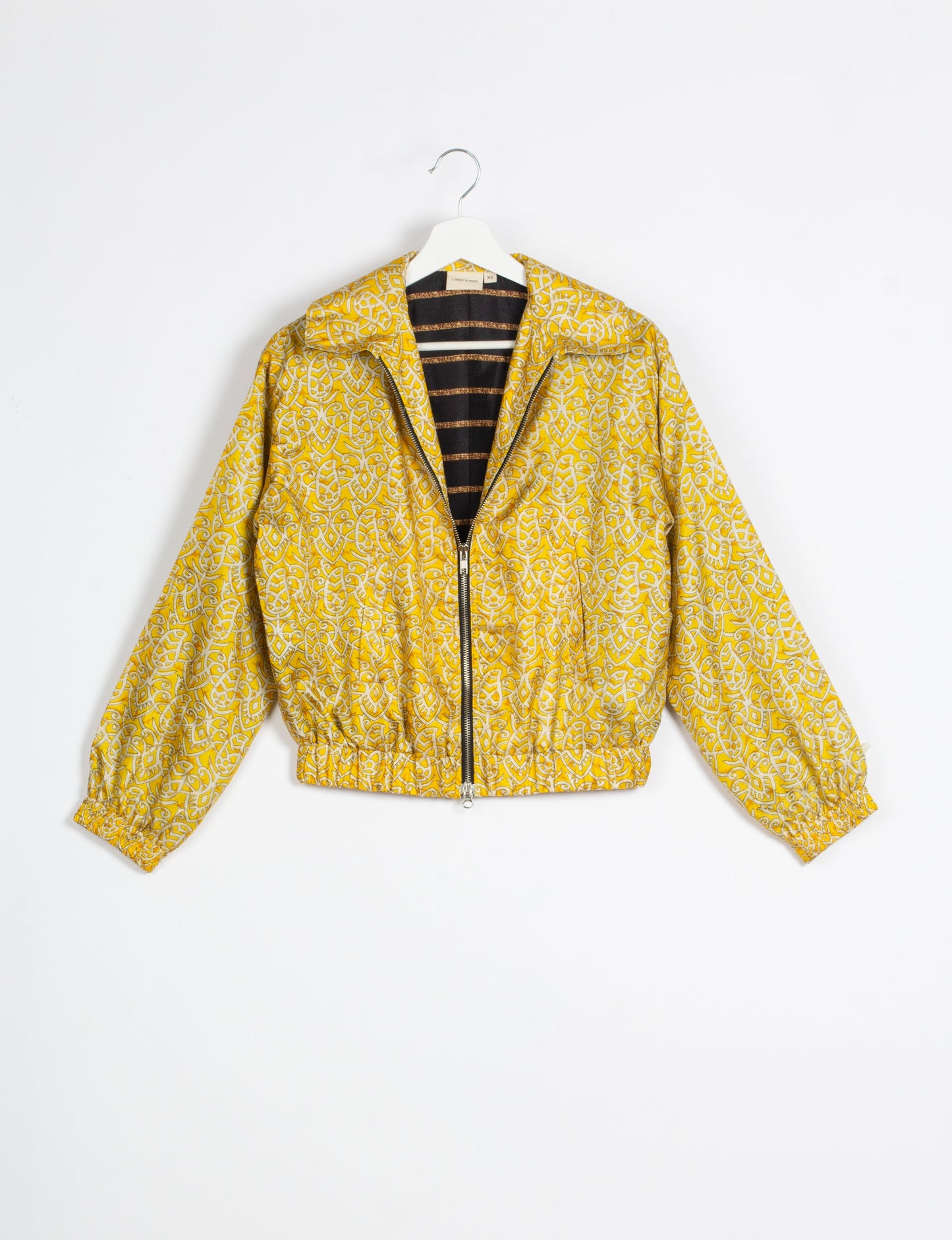 Stylish BOMBER JACKET, an upcycled clothing masterpiece with a cute cropped shape, elasticated details, and detachable metallic zipper. Contrast sari print lining adds a unique touch. Explore sustainable and eco-friendly fashion.