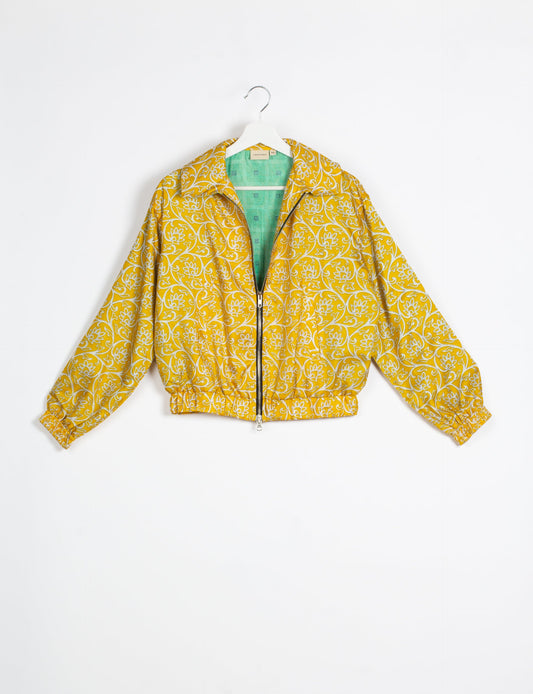 Stylish BOMBER JACKET, an upcycled clothing masterpiece with a cute cropped shape, elasticated details, and detachable metallic zipper. Contrast sari print lining adds a unique touch. Explore sustainable and eco-friendly fashion.