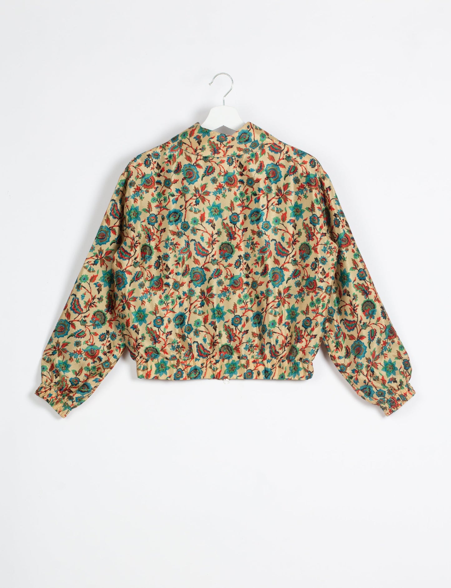 Stylish BOMBER JACKET, an upcycled clothing masterpiece with a cute cropped shape, elasticated details, and detachable metallic zipper. Contrast sari print lining adds a unique touch. Explore sustainable and eco-friendly fashion.