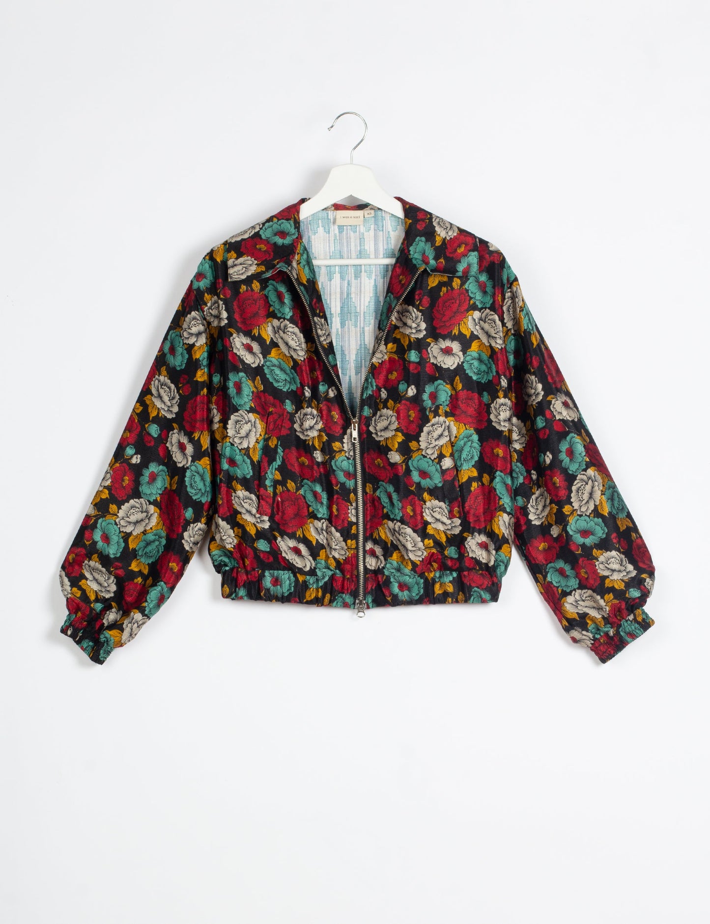 Stylish BOMBER JACKET, an upcycled clothing masterpiece with a cute cropped shape, elasticated details, and detachable metallic zipper. Contrast sari print lining adds a unique touch. Explore sustainable and eco-friendly fashion.