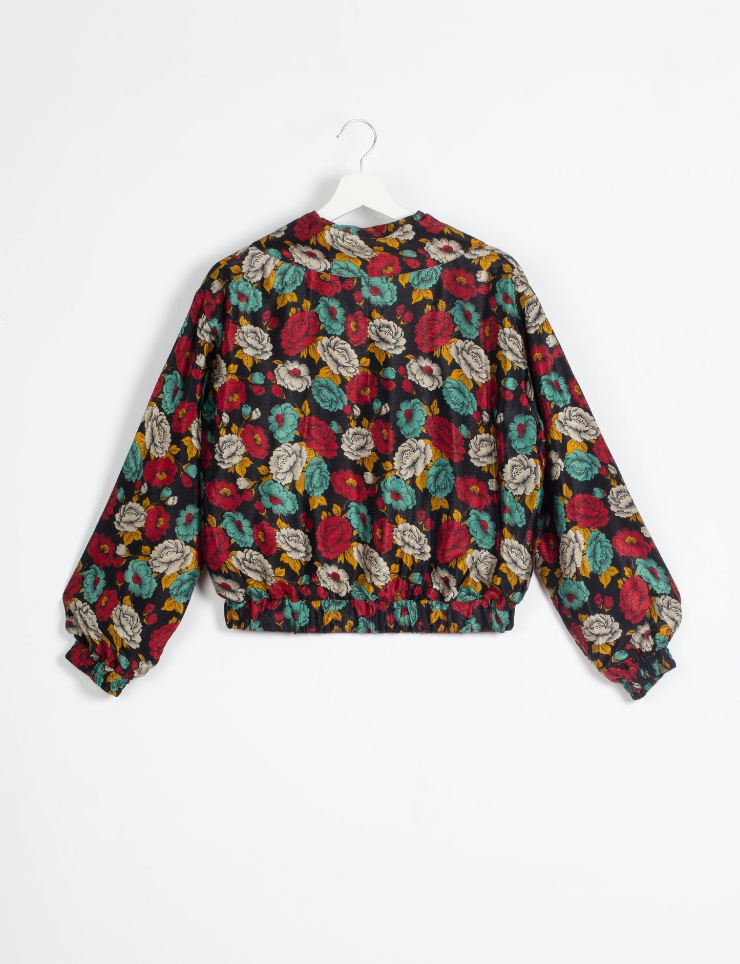 Stylish BOMBER JACKET, an upcycled clothing masterpiece with a cute cropped shape, elasticated details, and detachable metallic zipper. Contrast sari print lining adds a unique touch. Explore sustainable and eco-friendly fashion.