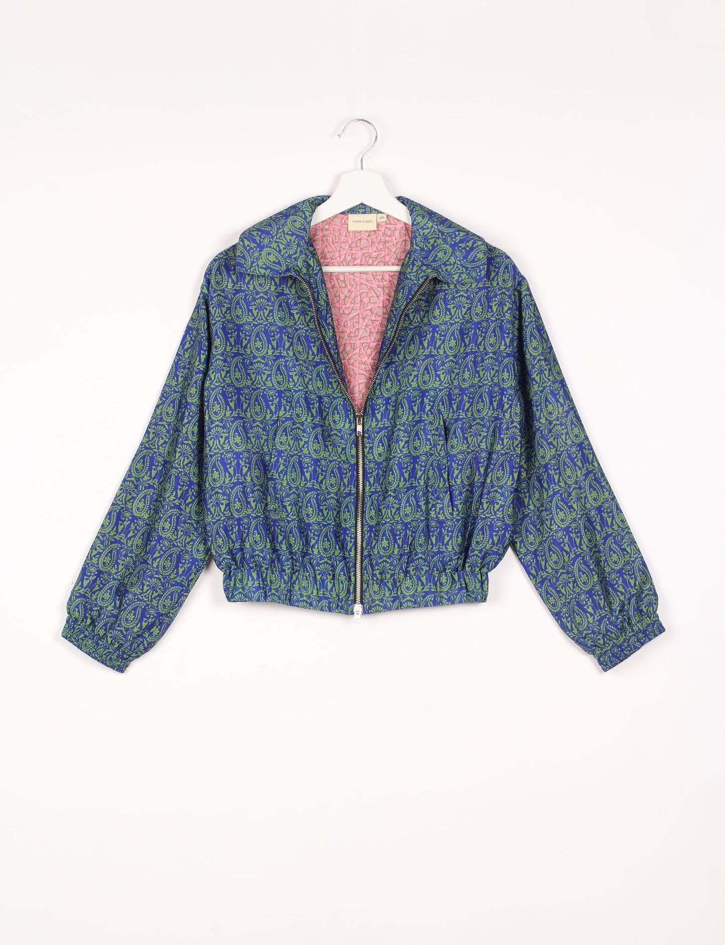 Stylish BOMBER JACKET, an upcycled clothing masterpiece with a cute cropped shape, elasticated details, and detachable metallic zipper. Contrast sari print lining adds a unique touch. Explore sustainable and eco-friendly fashion.