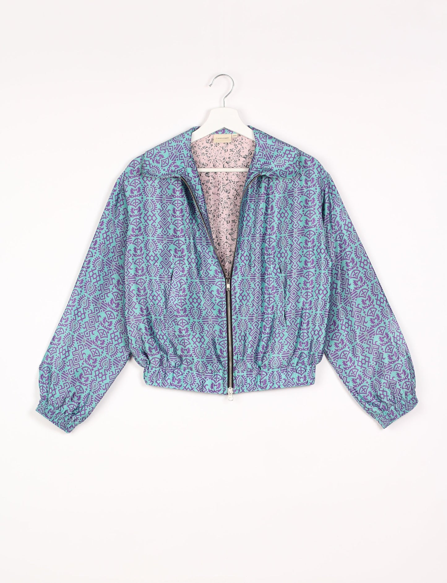 Stylish BOMBER JACKET, an upcycled clothing masterpiece with a cute cropped shape, elasticated details, and detachable metallic zipper. Contrast sari print lining adds a unique touch. Explore sustainable and eco-friendly fashion.