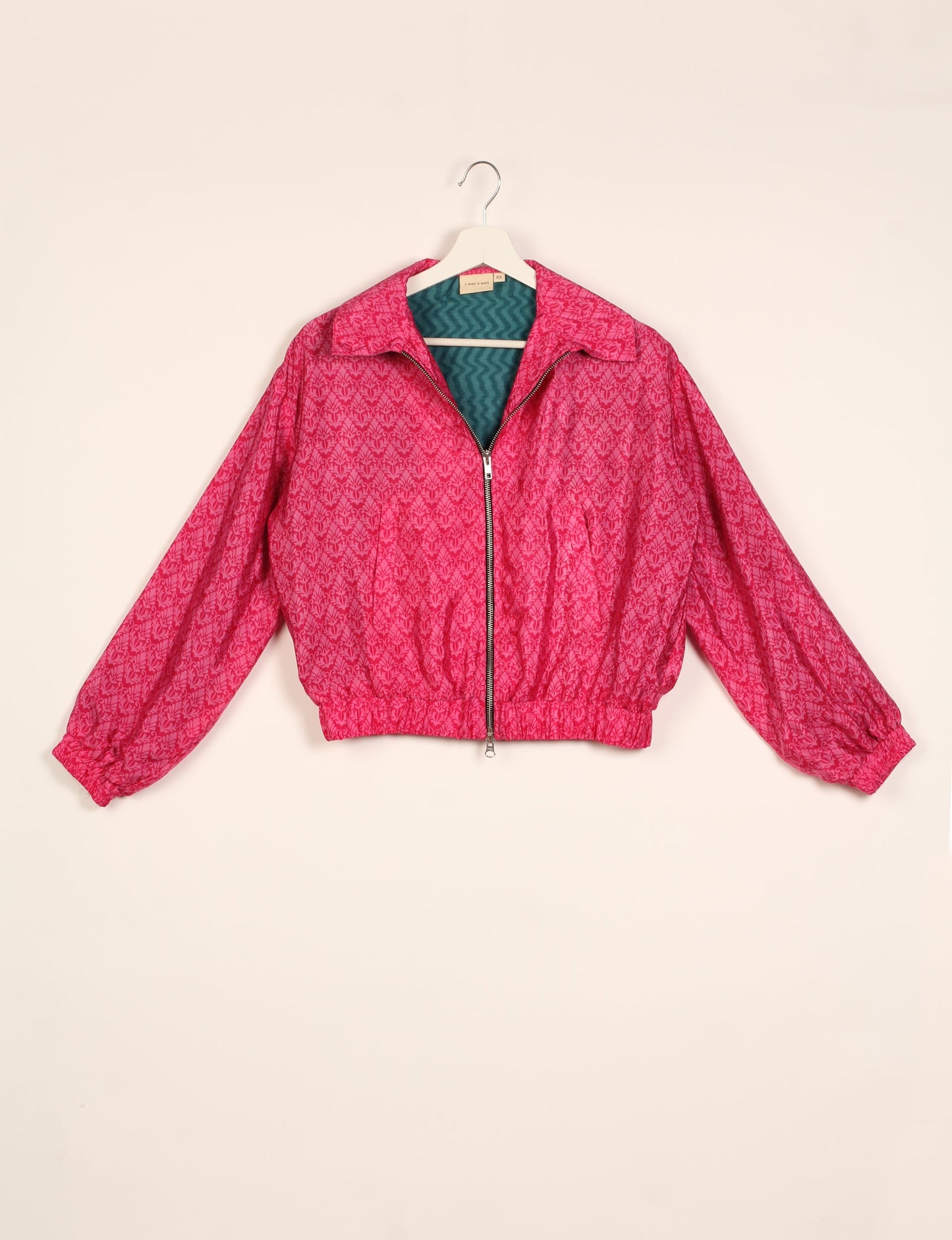 Stylish BOMBER JACKET, an upcycled clothing masterpiece with a cute cropped shape, elasticated details, and detachable metallic zipper. Contrast sari print lining adds a unique touch. Explore sustainable and eco-friendly fashion.