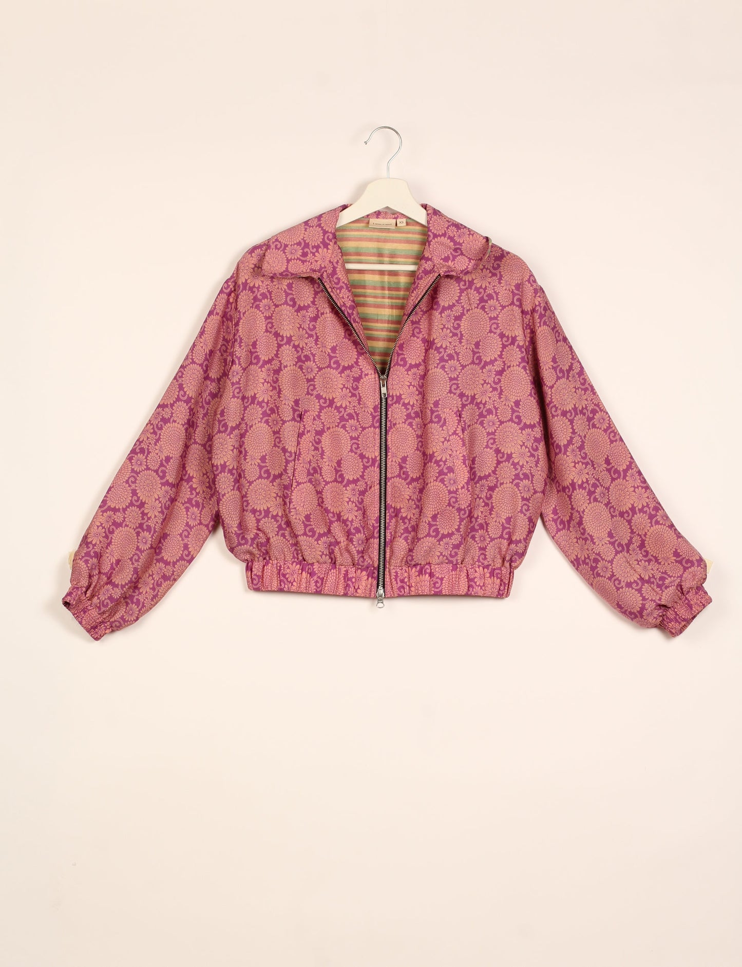 Stylish BOMBER JACKET, an upcycled clothing masterpiece with a cute cropped shape, elasticated details, and detachable metallic zipper. Contrast sari print lining adds a unique touch. Explore sustainable and eco-friendly fashion.