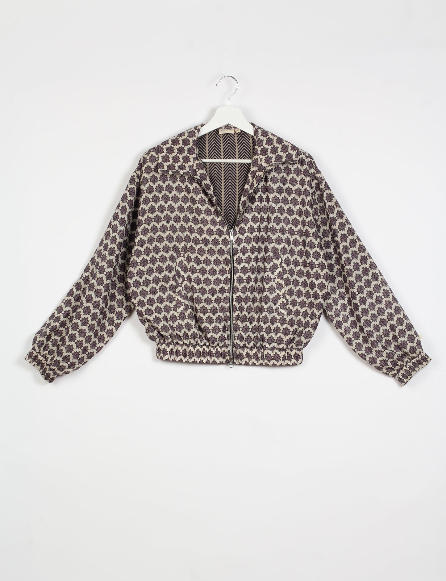 Stylish BOMBER JACKET, an upcycled clothing masterpiece with a cute cropped shape, elasticated details, and detachable metallic zipper. Contrast sari print lining adds a unique touch. Explore sustainable and eco-friendly fashion.