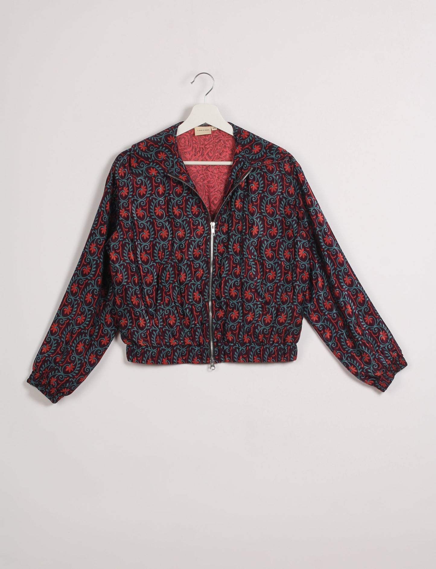 Stylish BOMBER JACKET, an upcycled clothing masterpiece with a cute cropped shape, elasticated details, and detachable metallic zipper. Contrast sari print lining adds a unique touch. Explore sustainable and eco-friendly fashion.