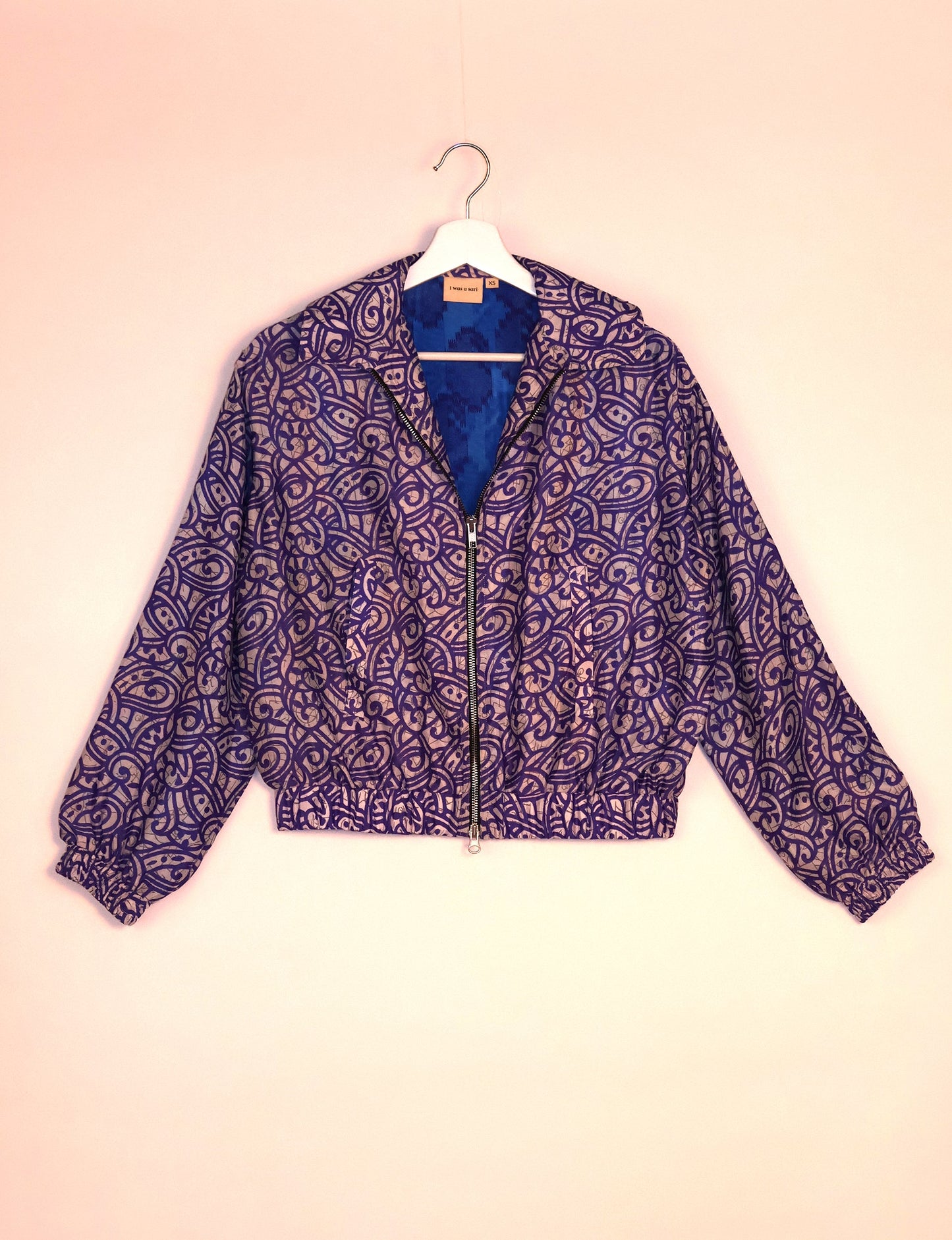 Stylish BOMBER JACKET, an upcycled clothing masterpiece with a cute cropped shape, elasticated details, and detachable metallic zipper. Contrast sari print lining adds a unique touch. Explore sustainable and eco-friendly fashion.