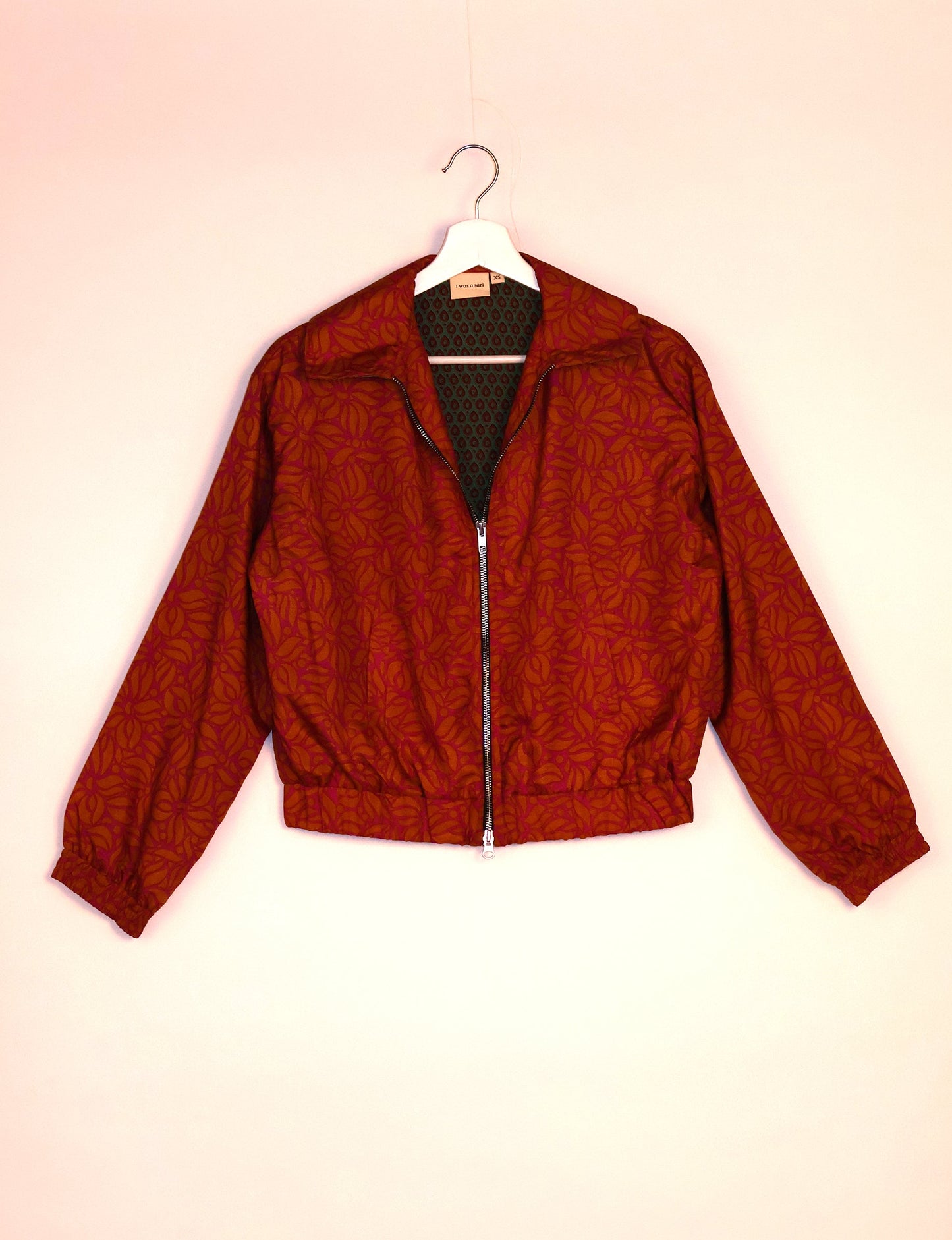 Stylish BOMBER JACKET, an upcycled clothing masterpiece with a cute cropped shape, elasticated details, and detachable metallic zipper. Contrast sari print lining adds a unique touch. Explore sustainable and eco-friendly fashion.