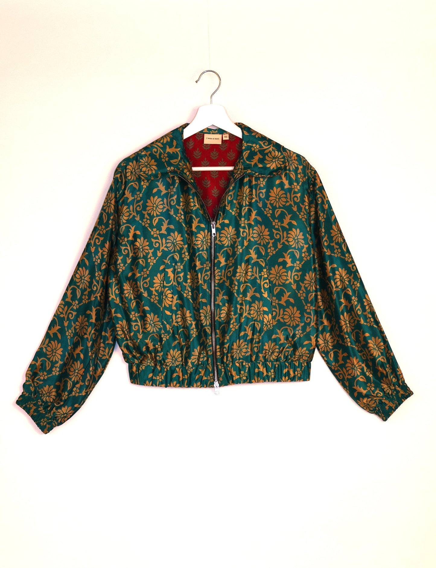 Stylish BOMBER JACKET, an upcycled clothing masterpiece with a cute cropped shape, elasticated details, and detachable metallic zipper. Contrast sari print lining adds a unique touch. Explore sustainable and eco-friendly fashion.