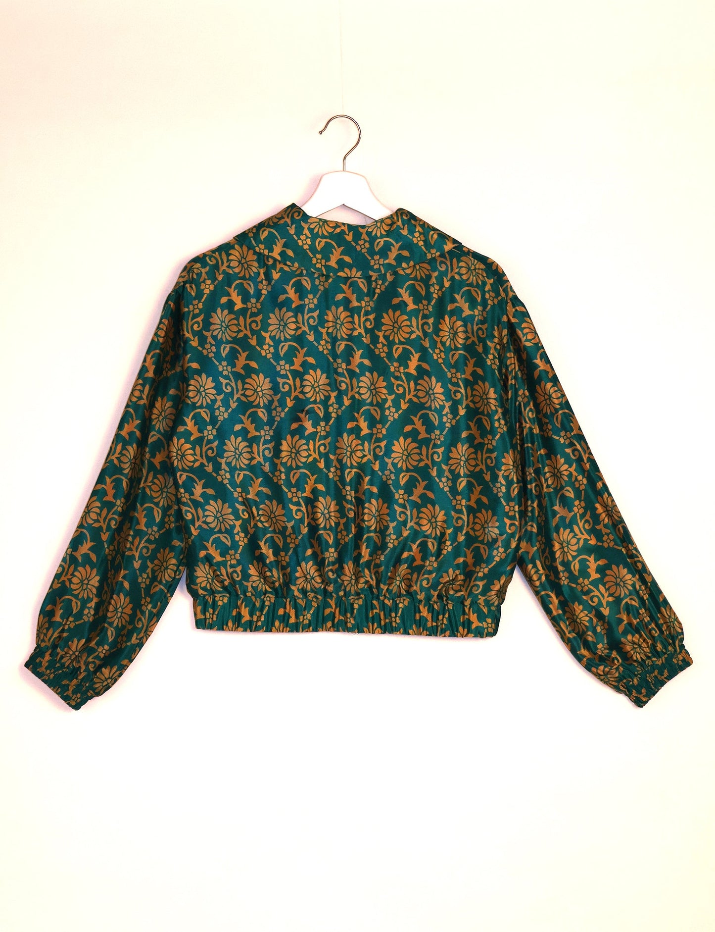 Stylish BOMBER JACKET, an upcycled clothing masterpiece with a cute cropped shape, elasticated details, and detachable metallic zipper. Contrast sari print lining adds a unique touch. Explore sustainable and eco-friendly fashion.