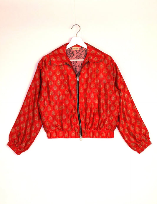 Stylish BOMBER JACKET, an upcycled clothing masterpiece with a cute cropped shape, elasticated details, and detachable metallic zipper. Contrast sari print lining adds a unique touch. Explore sustainable and eco-friendly fashion.