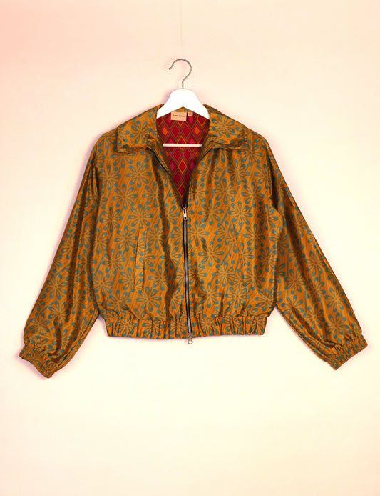 Stylish BOMBER JACKET, an upcycled clothing masterpiece with a cute cropped shape, elasticated details, and detachable metallic zipper. Contrast sari print lining adds a unique touch. Explore sustainable and eco-friendly fashion.