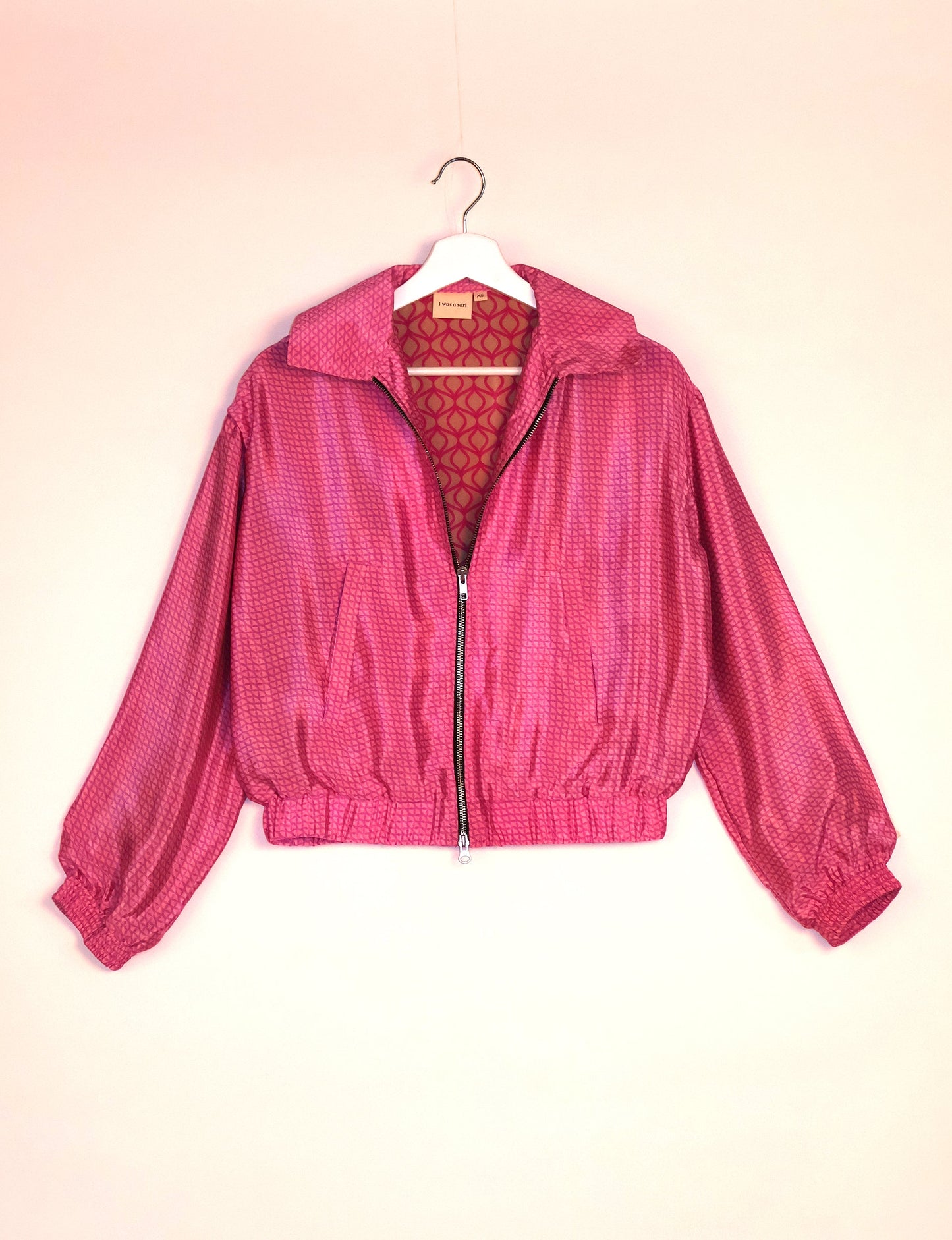 Stylish BOMBER JACKET, an upcycled clothing masterpiece with a cute cropped shape, elasticated details, and detachable metallic zipper. Contrast sari print lining adds a unique touch. Explore sustainable and eco-friendly fashion.