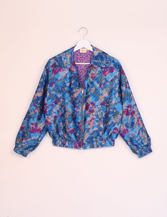 Stylish BOMBER JACKET, an upcycled clothing masterpiece with a cute cropped shape, elasticated details, and detachable metallic zipper. Contrast sari print lining adds a unique touch. Explore sustainable and eco-friendly fashion.