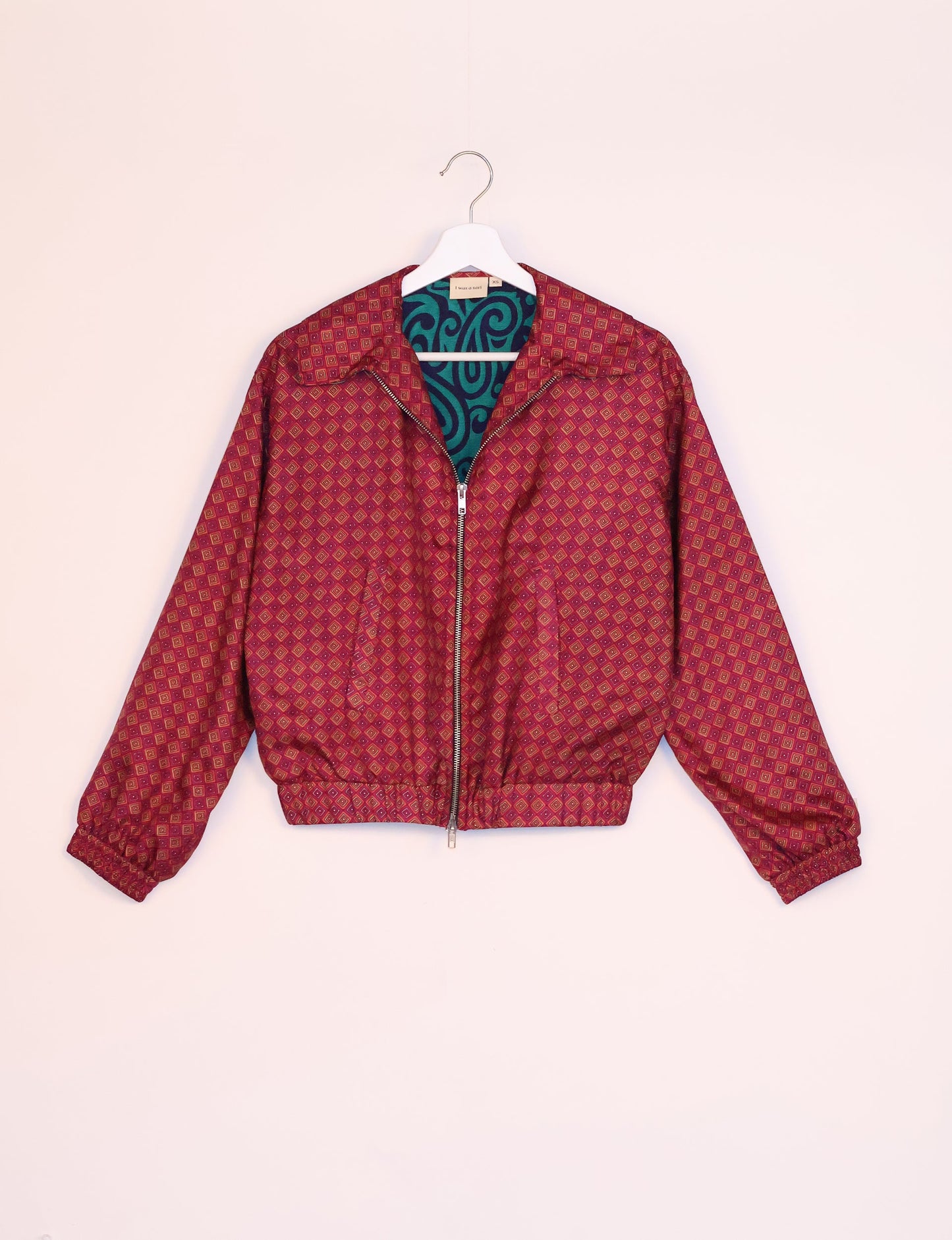 Stylish BOMBER JACKET, an upcycled clothing masterpiece with a cute cropped shape, elasticated details, and detachable metallic zipper. Contrast sari print lining adds a unique touch. Explore sustainable and eco-friendly fashion.